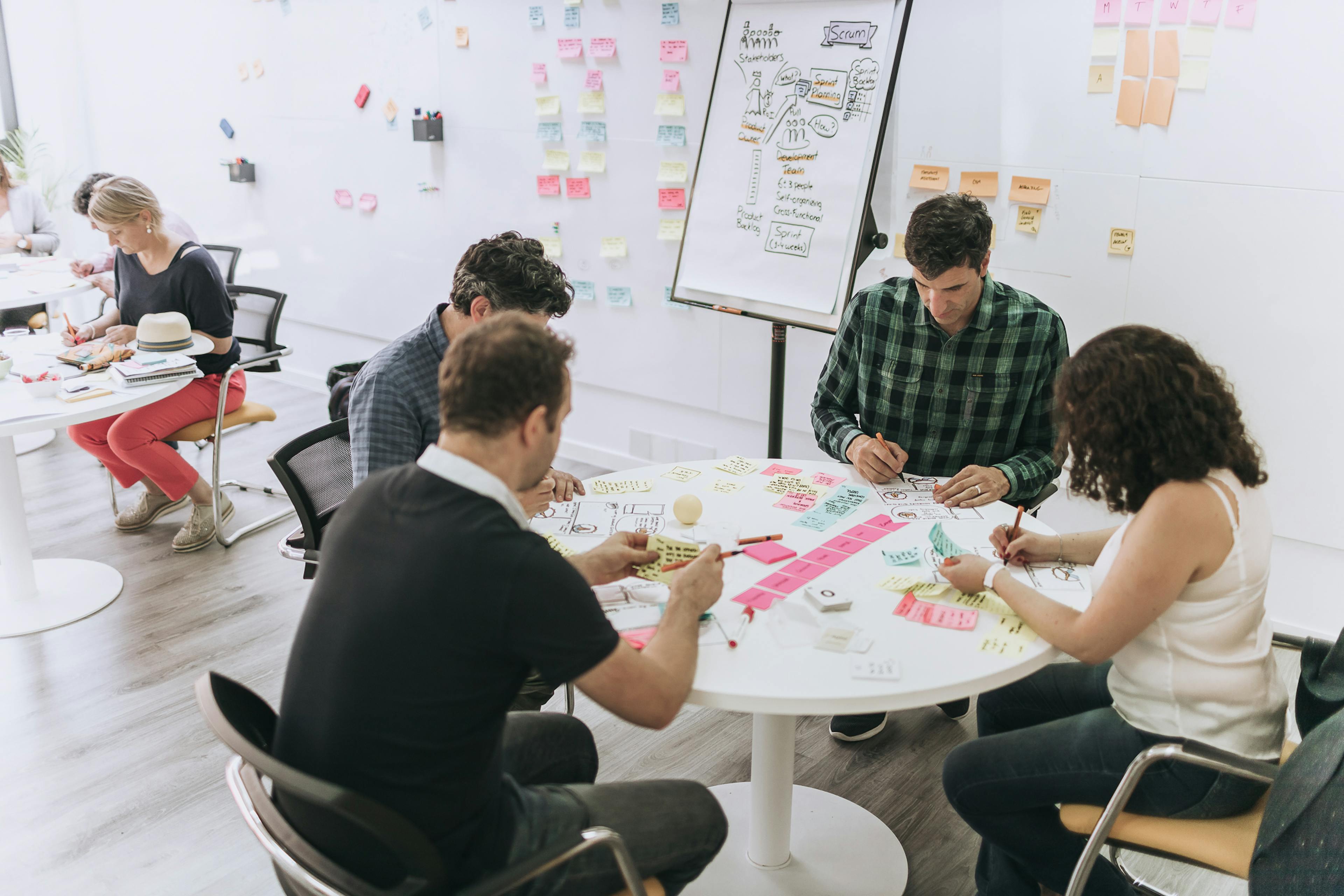 a group of colleagues collaborating around a table in an office