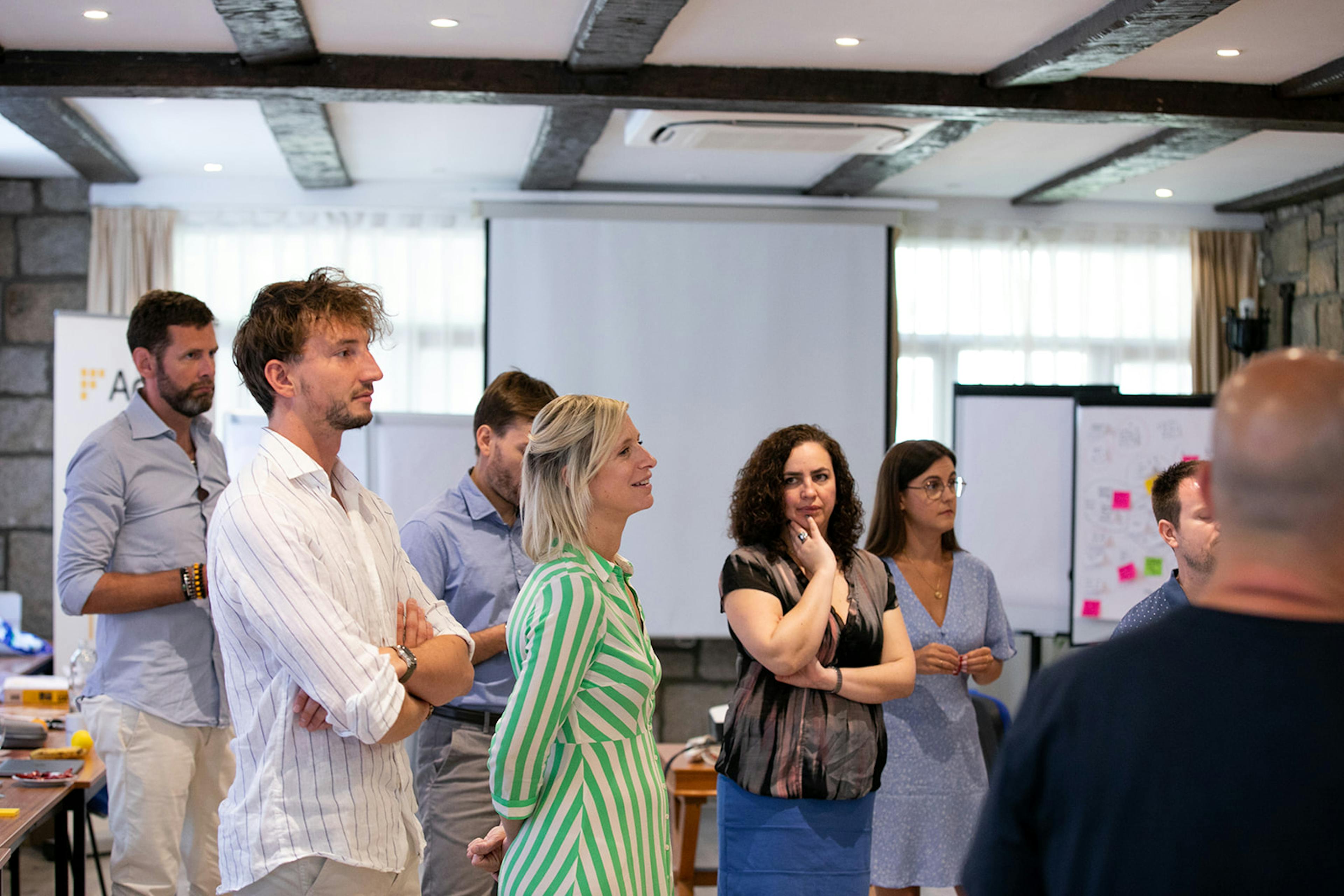 A team gathered in front of a board