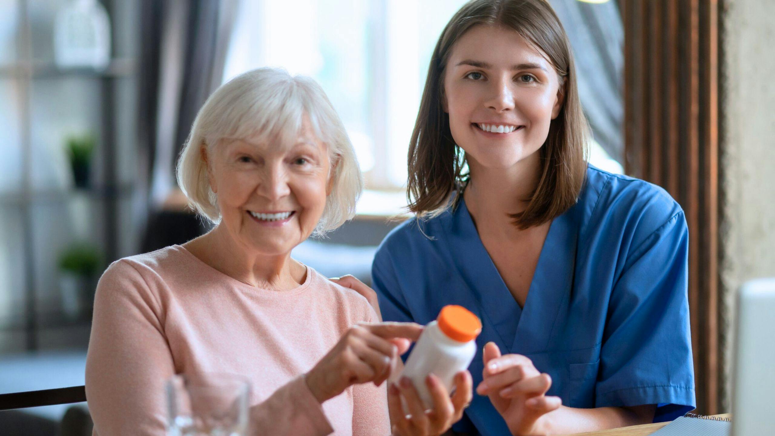 une aidante qui fait un rappel à une personne âgée pour lui rappeler qu'il est temps de prendre son médicament