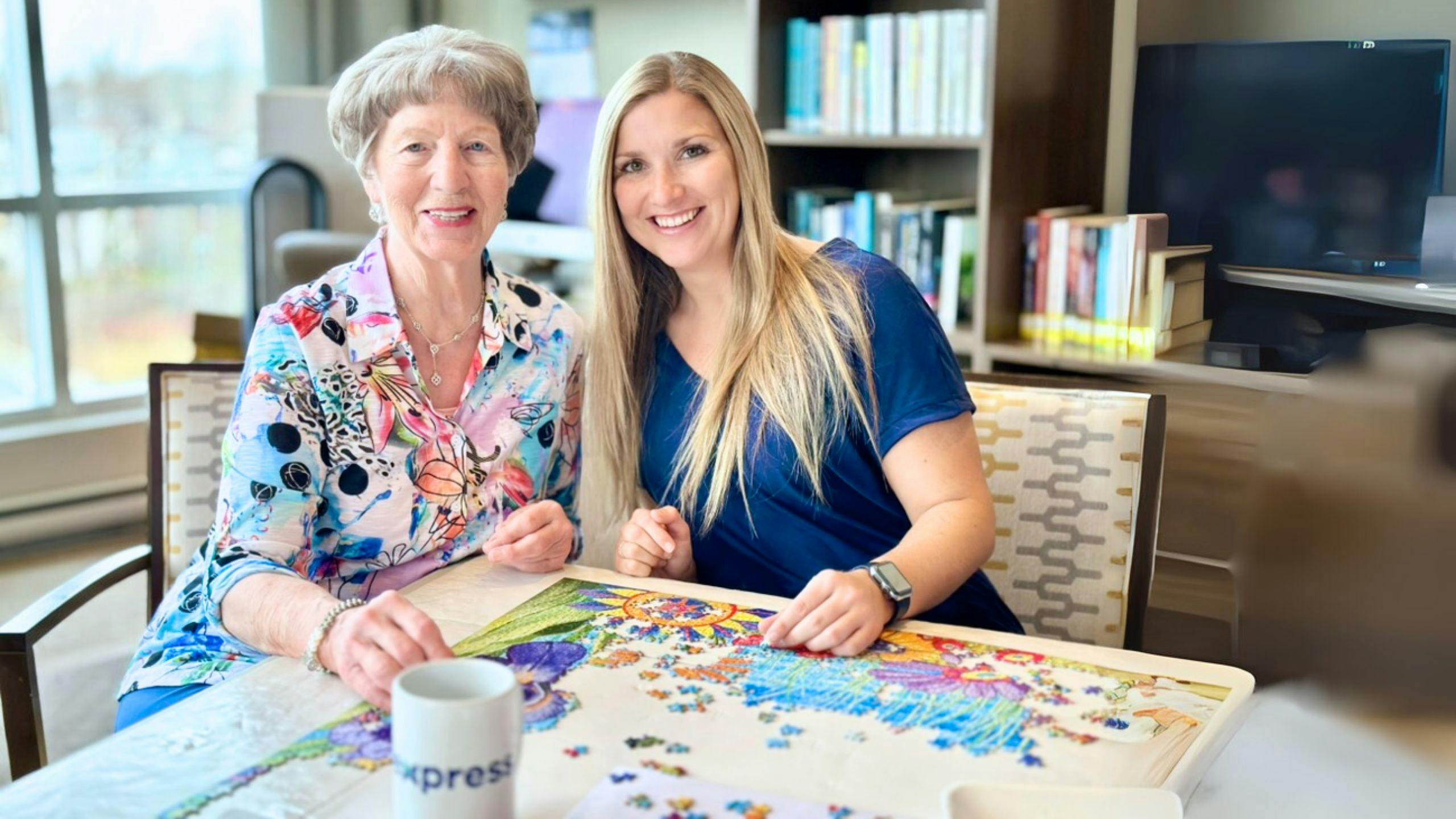 Aidante à domicile qui joue à un jeu de mémoire avec une personne âgée pour stimuler ses capacités cognitives.