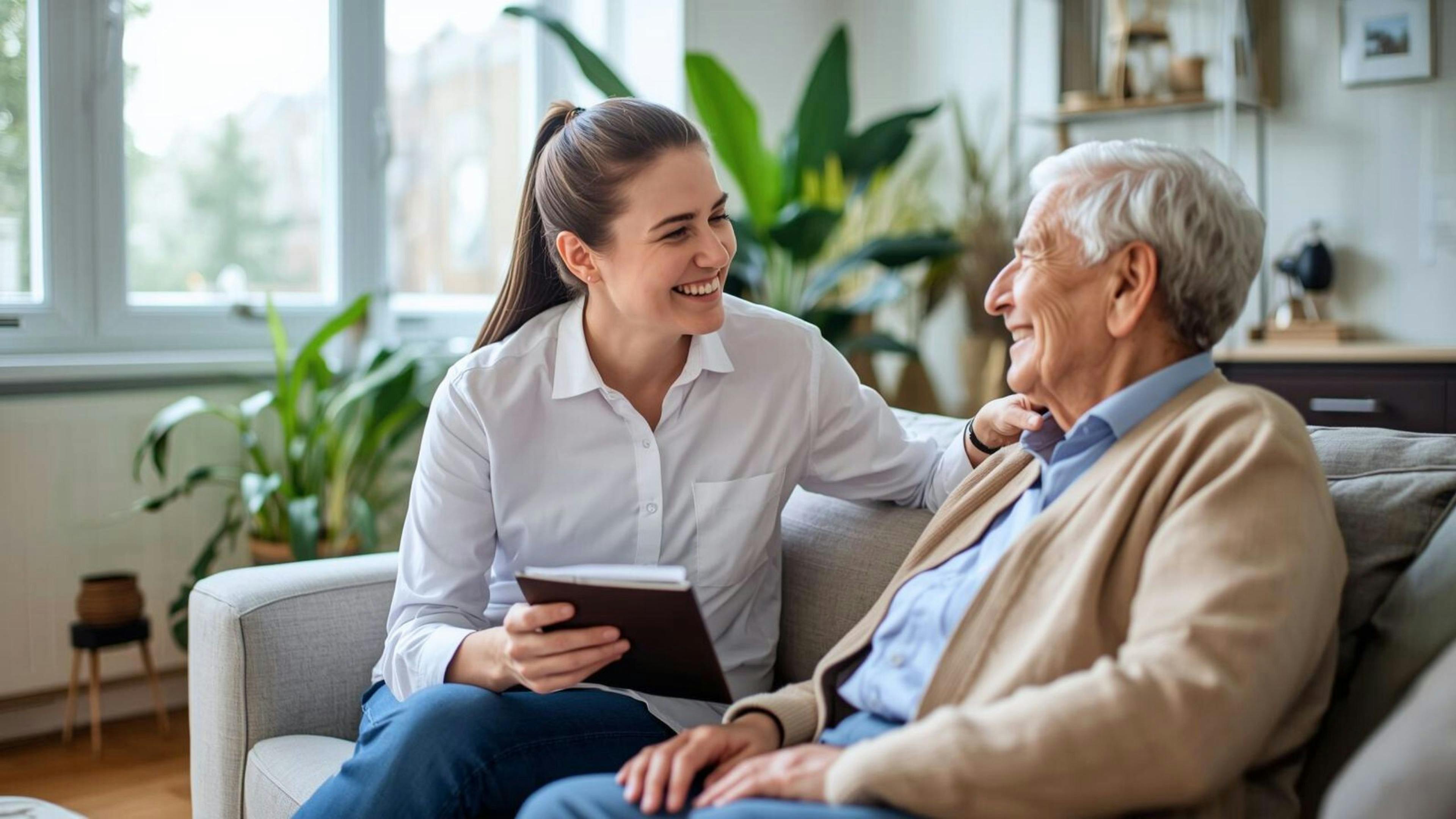 Une technicienne en travail social d’Aidexpress discute avec un homme âgé lors d’une rencontre à domicile, illustrant l’emploi de technicienne en travail social en soutien à domicile.