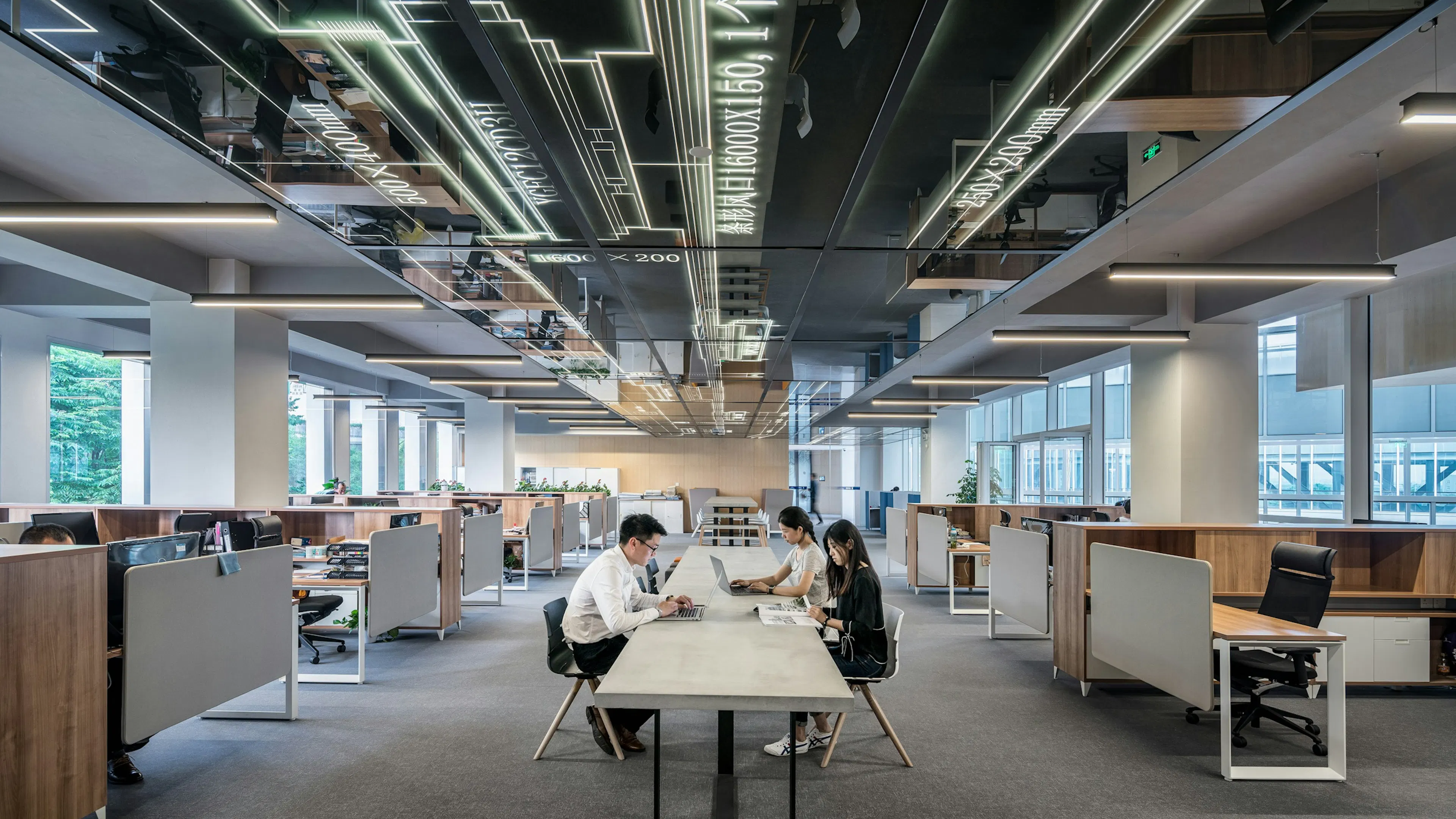 People working around a shared table in a light-filled open office