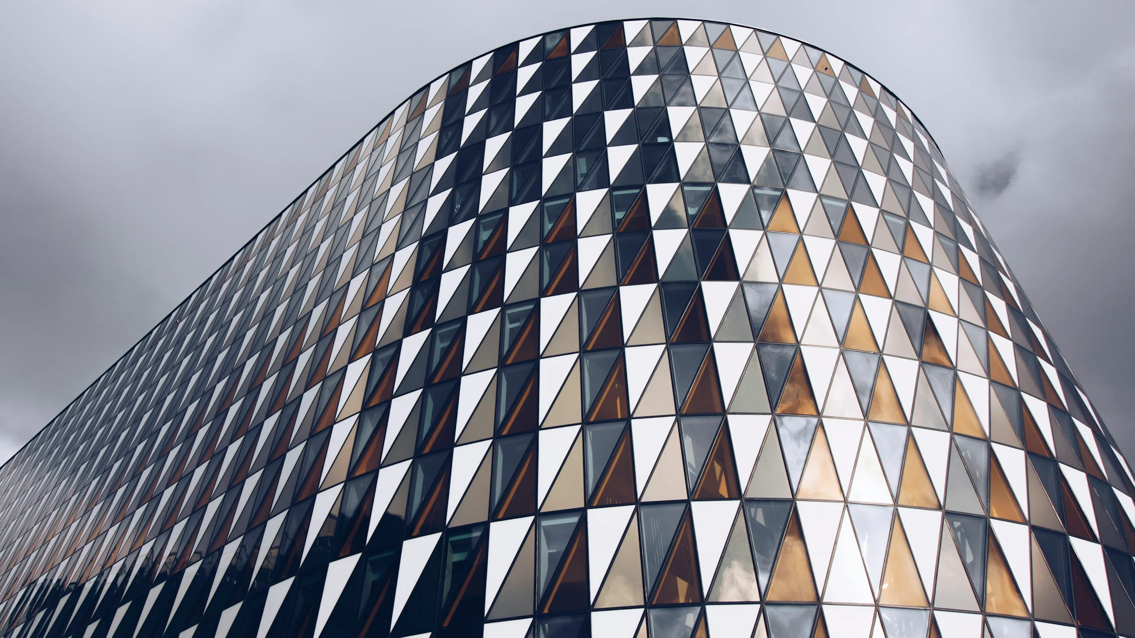 Triangular glass panels on a curved building in Stockholm