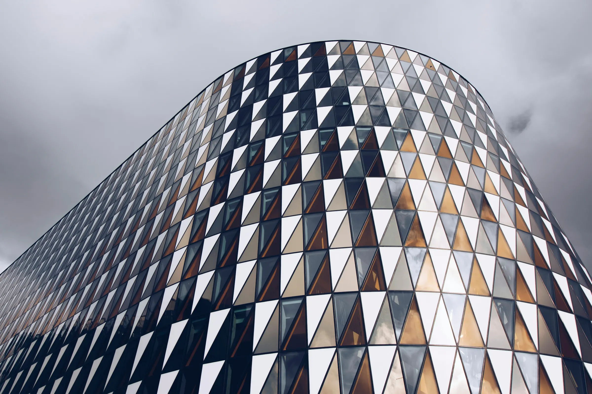 Triangular glass panels on a curved building in Stockholm