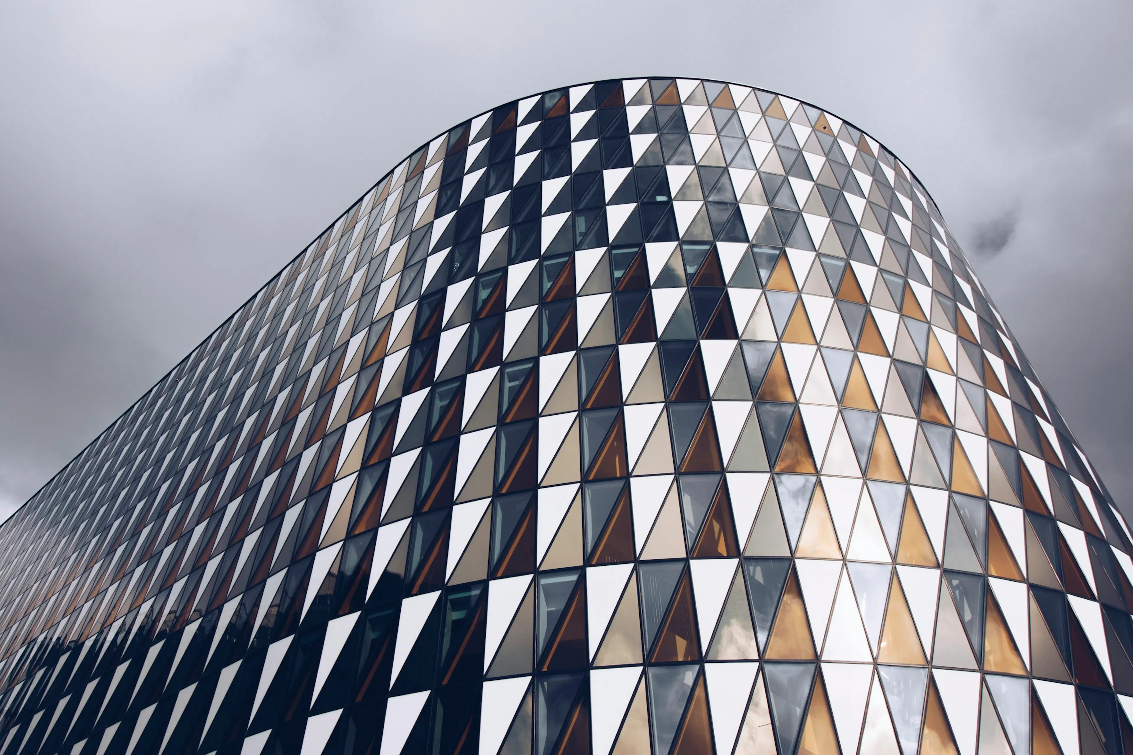 Triangular glass panels on a curved building in Stockholm