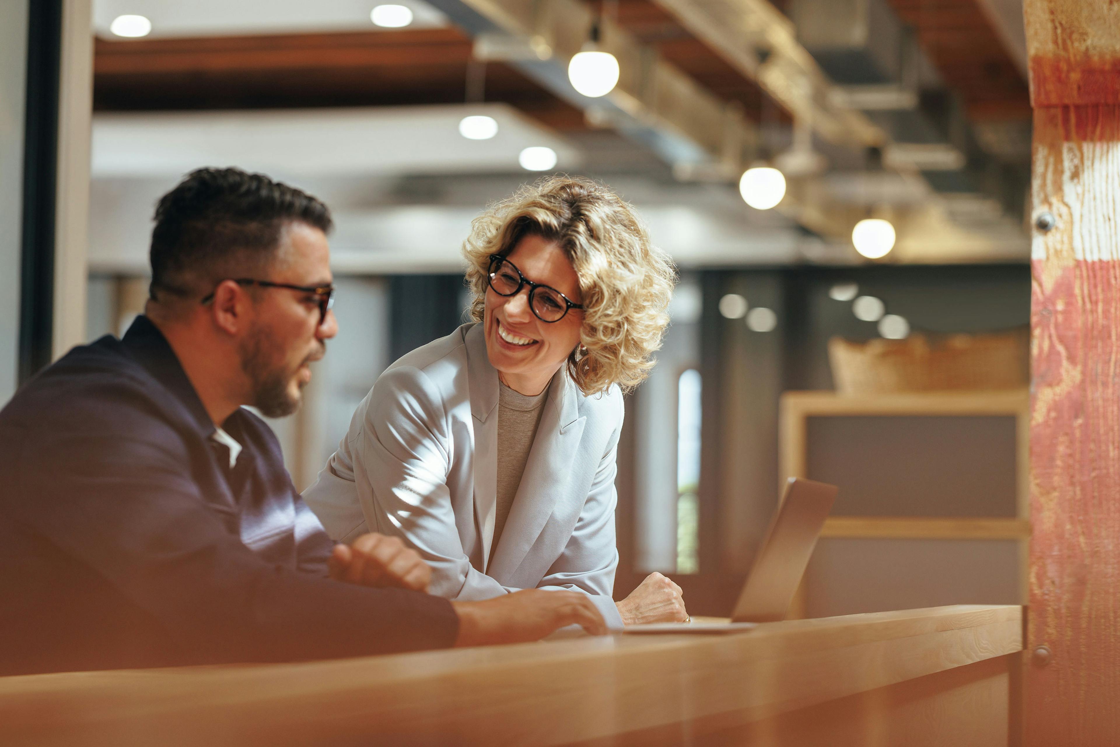 A man and a woman talking in an office setting
