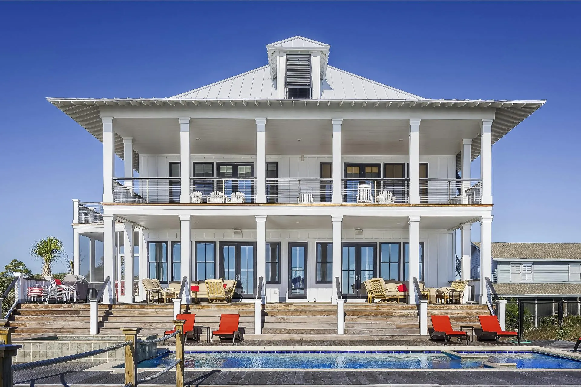 Mansion with two tiered decks and pool