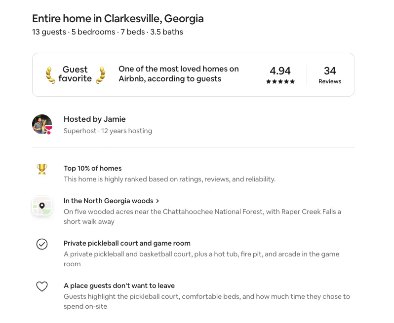 Screenshot of an Airbnb listing in Clarkesville, Georgia, hosted by the author, showing the Guest Favorite badge, a 4.94 rating from 34 reviews, the Top 10% of homes line and three AI-written highlights: In the North Georgia woods, Private pickleball court and game room, and A place guests don’t want to leave