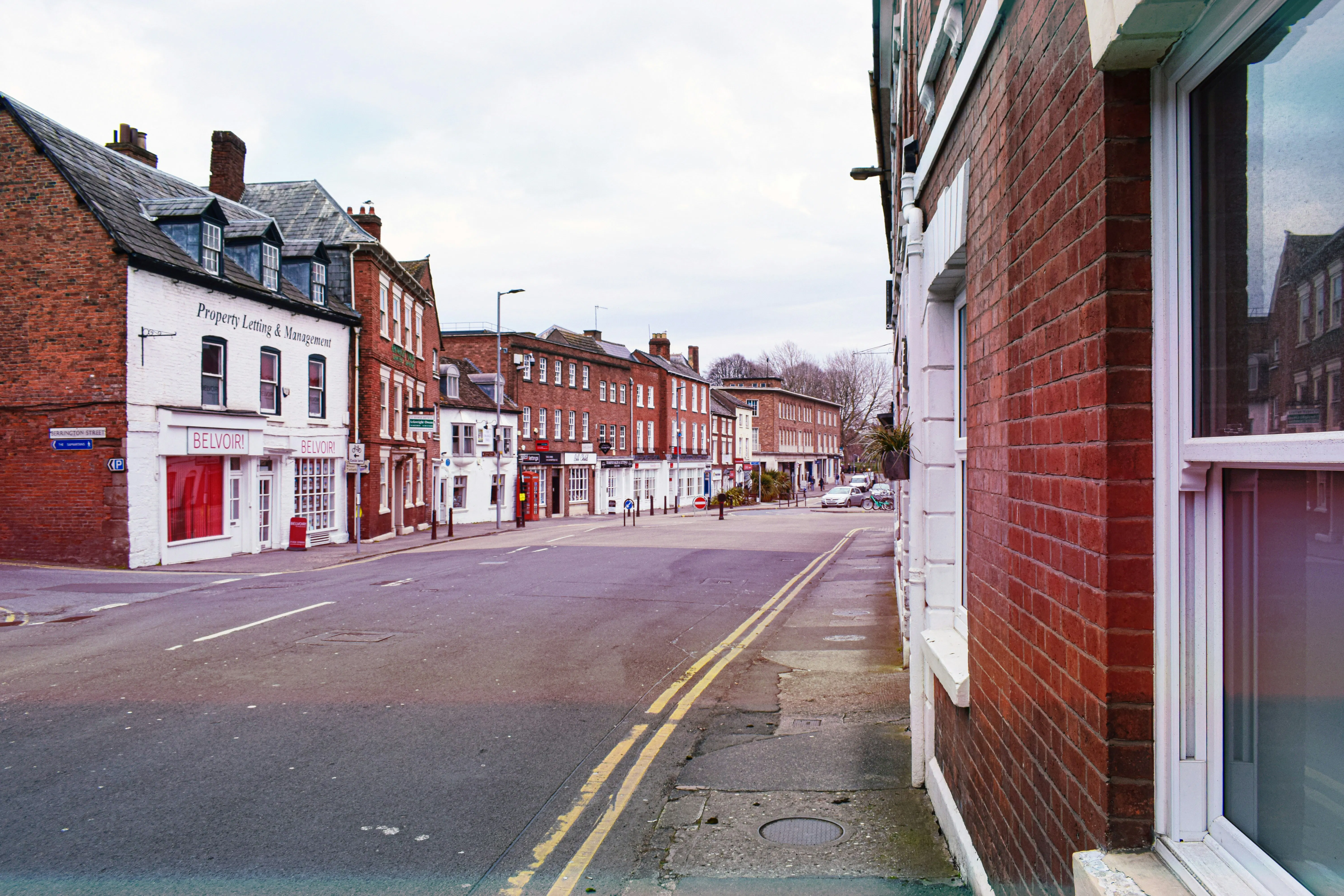 Hereford street with red brick buildings and Belvoir! shop.