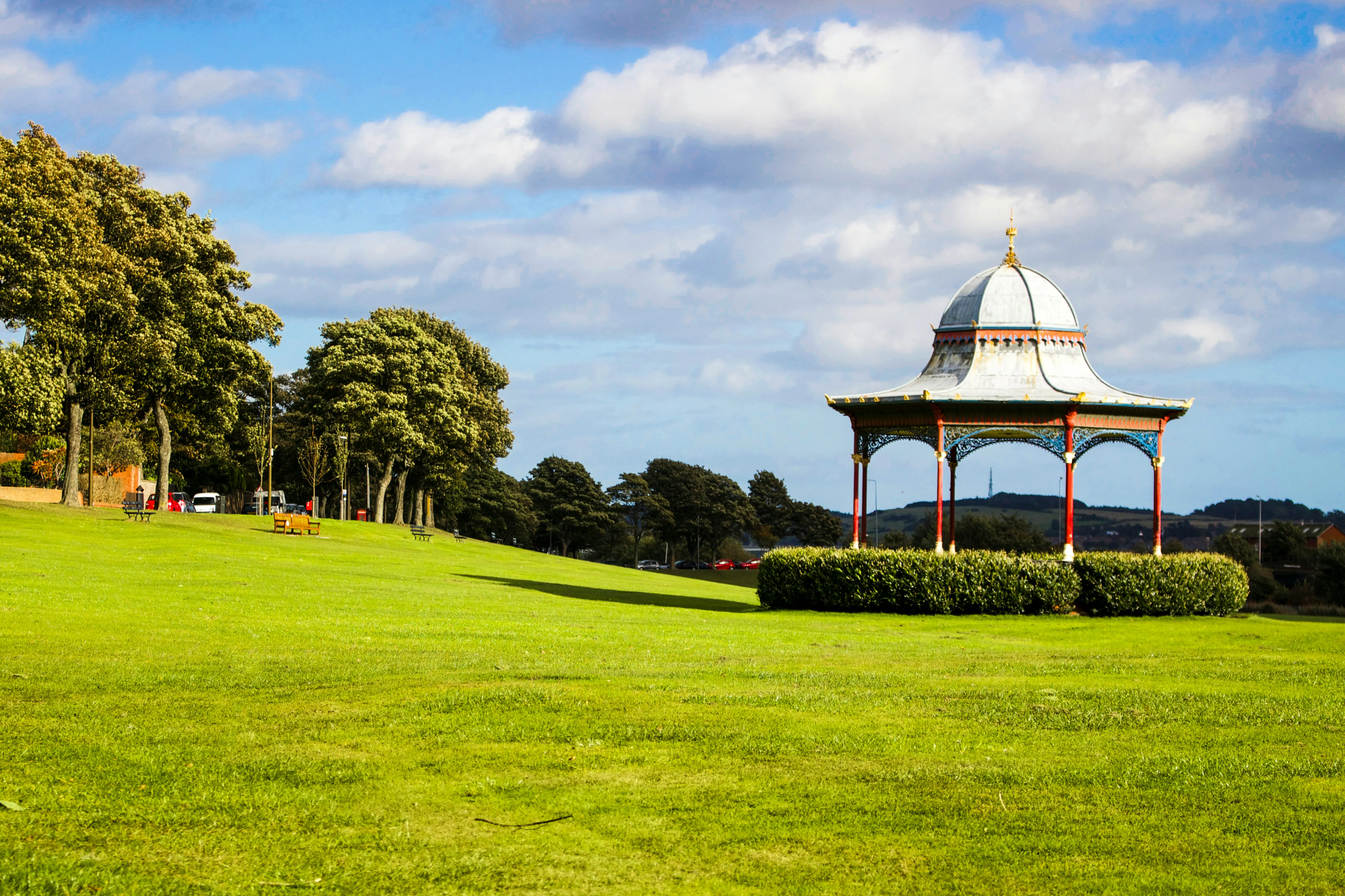 Ornate park gazebo on a sunny green lawn