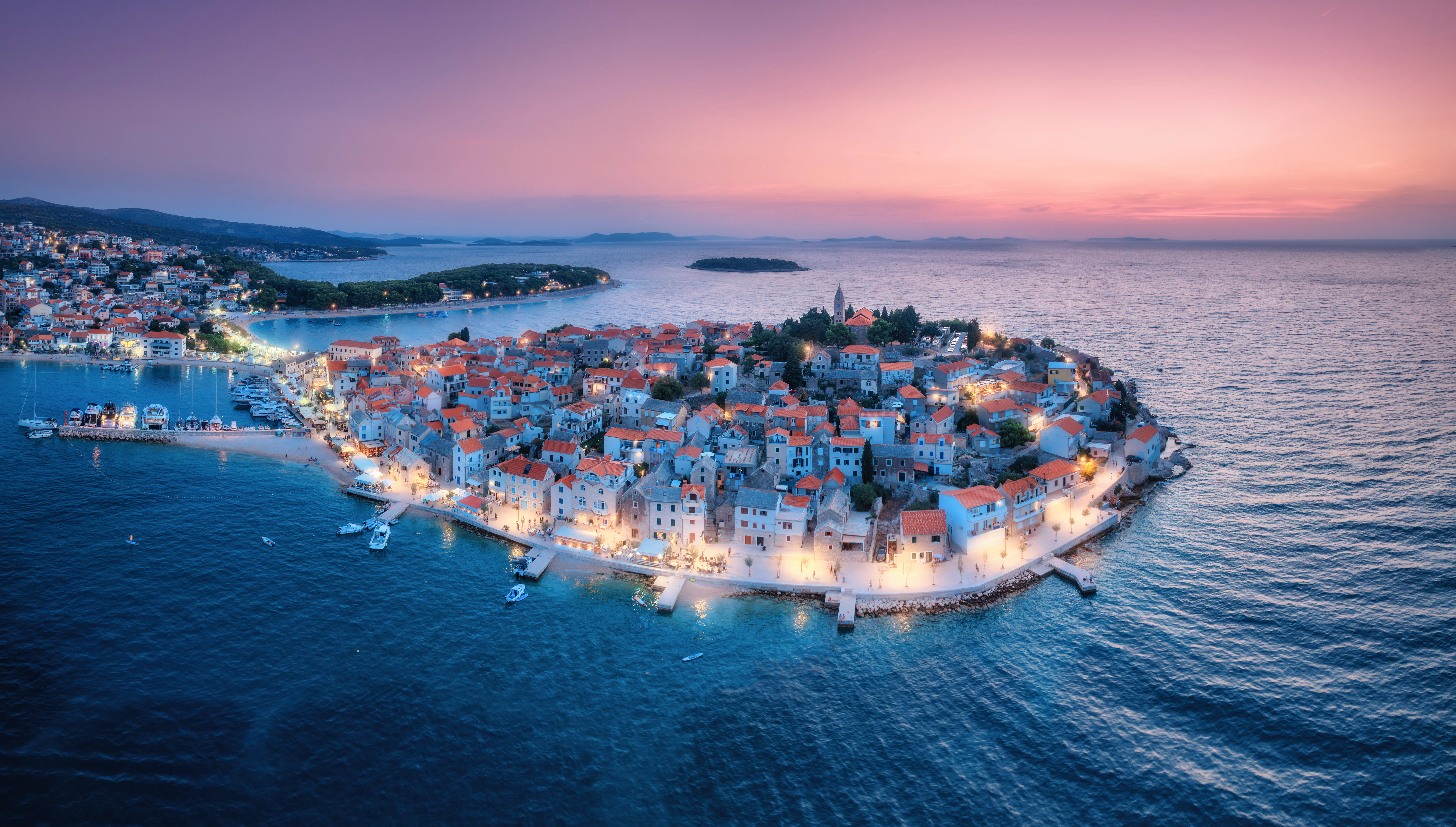 Aeriel view of old town with street lights on island at night. Summer in Primosten, Croatia