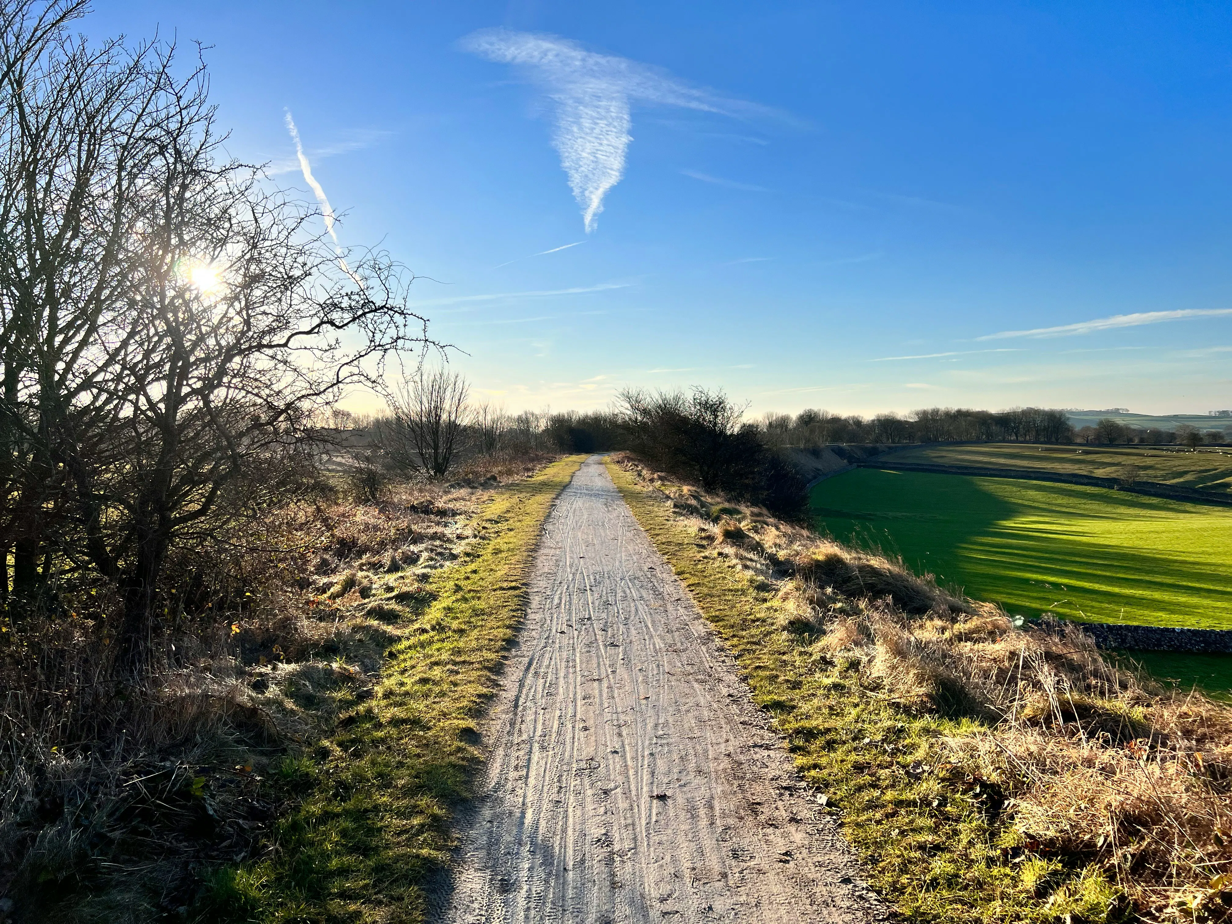 Sunny countryside dirt path on a clear day