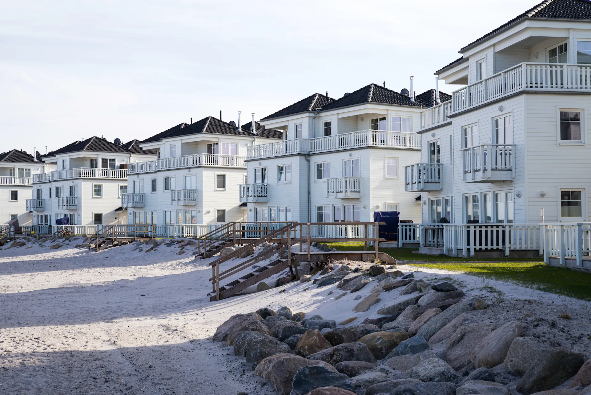 White wooden houses on the beach.