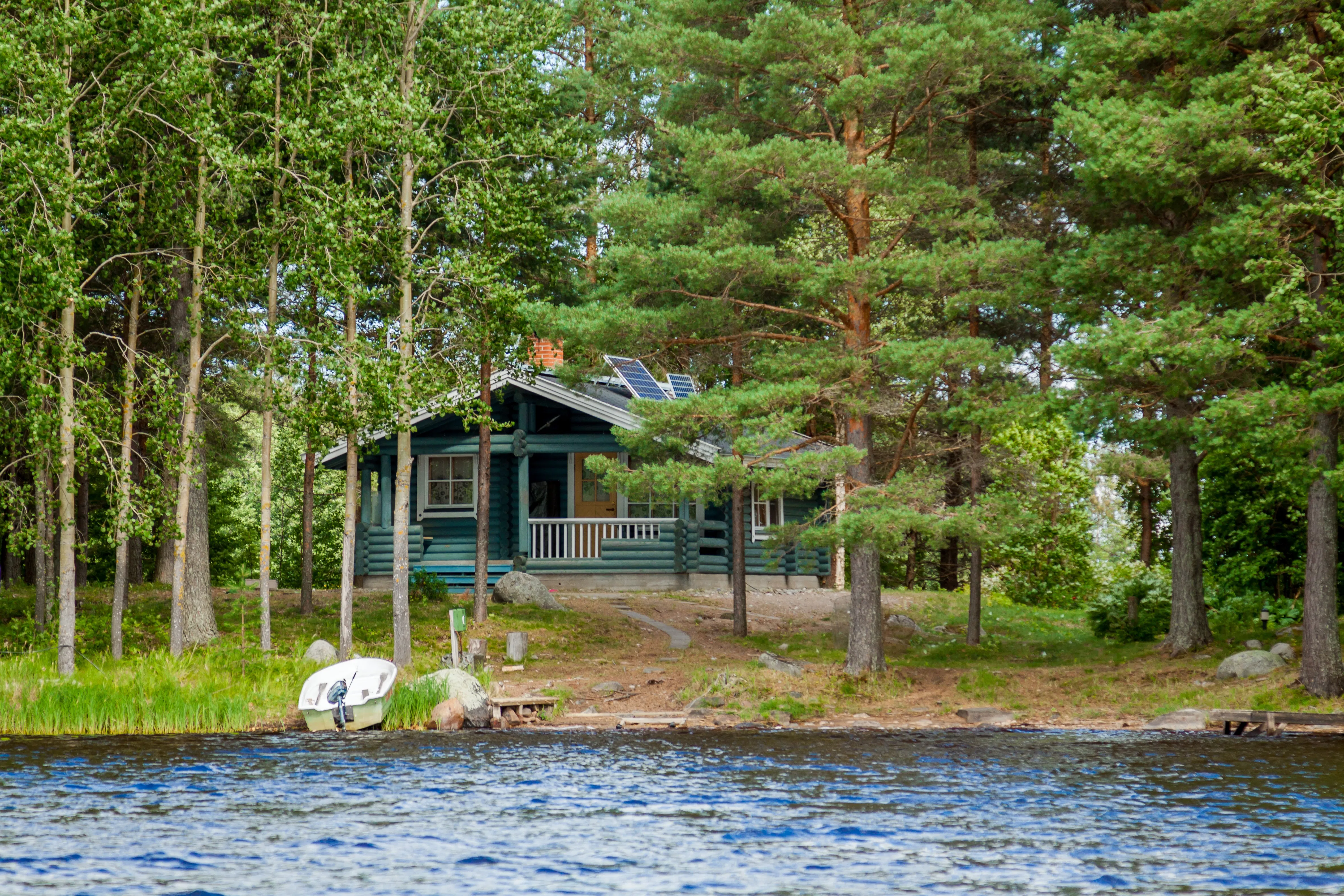 Green cabin on lake