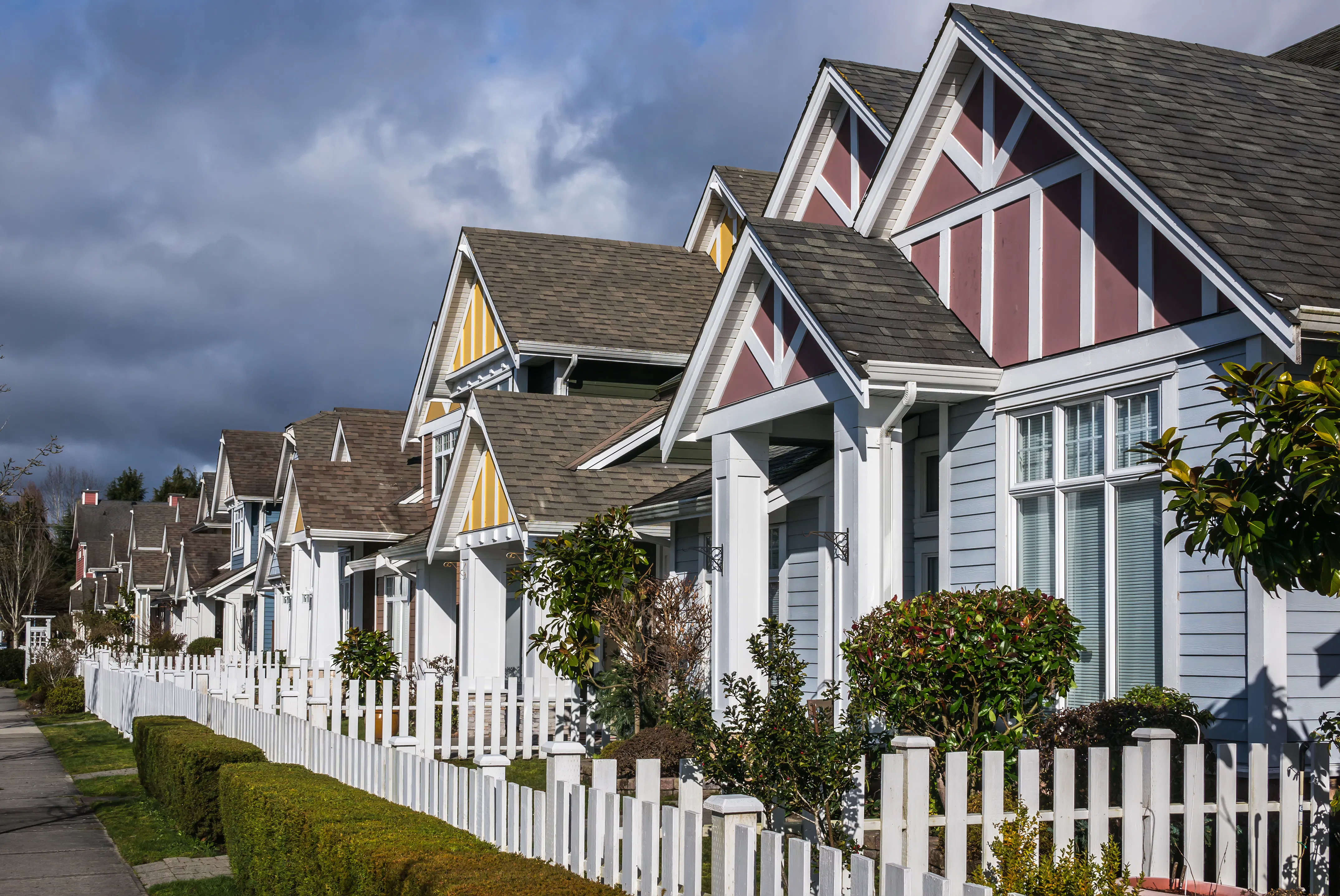 Row houses with white picket fences