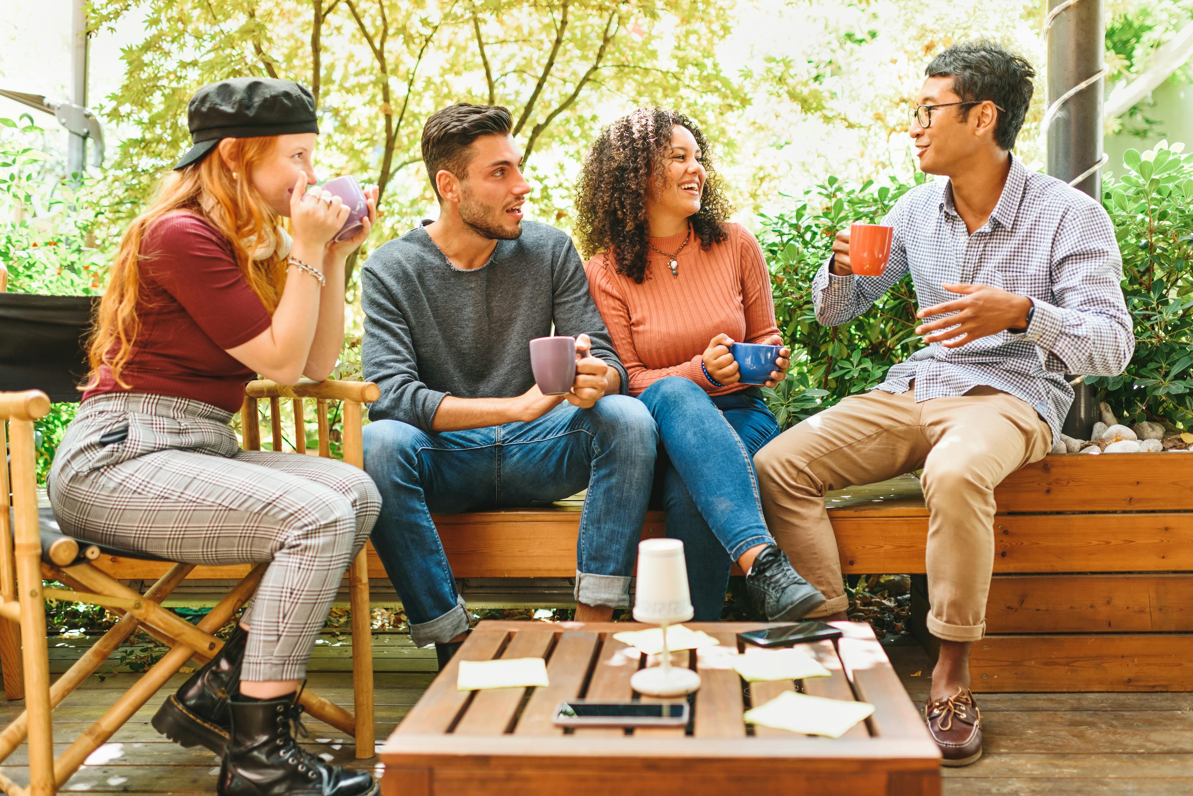 Friends drinking coffee on patio