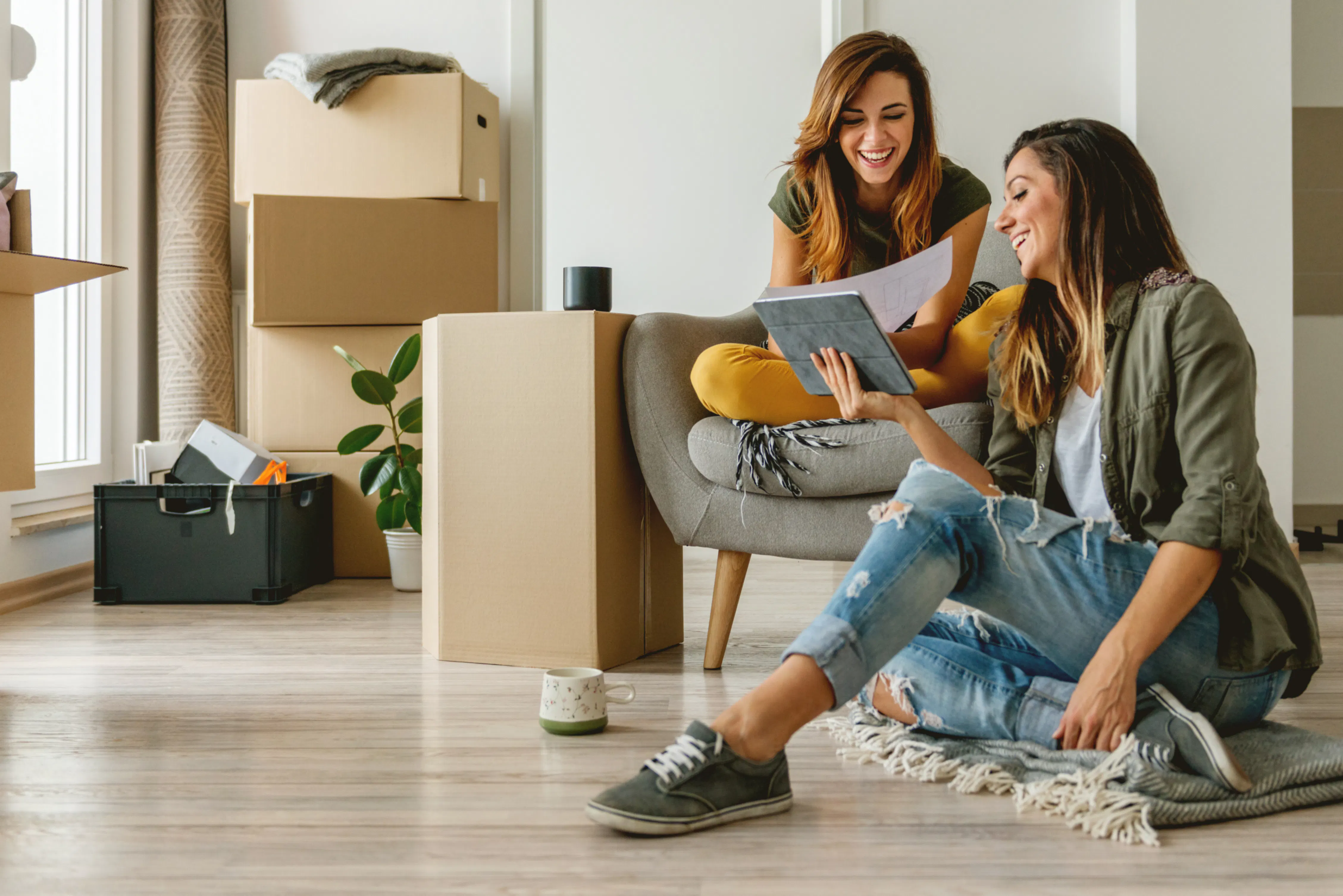 Two women unpacking apartment