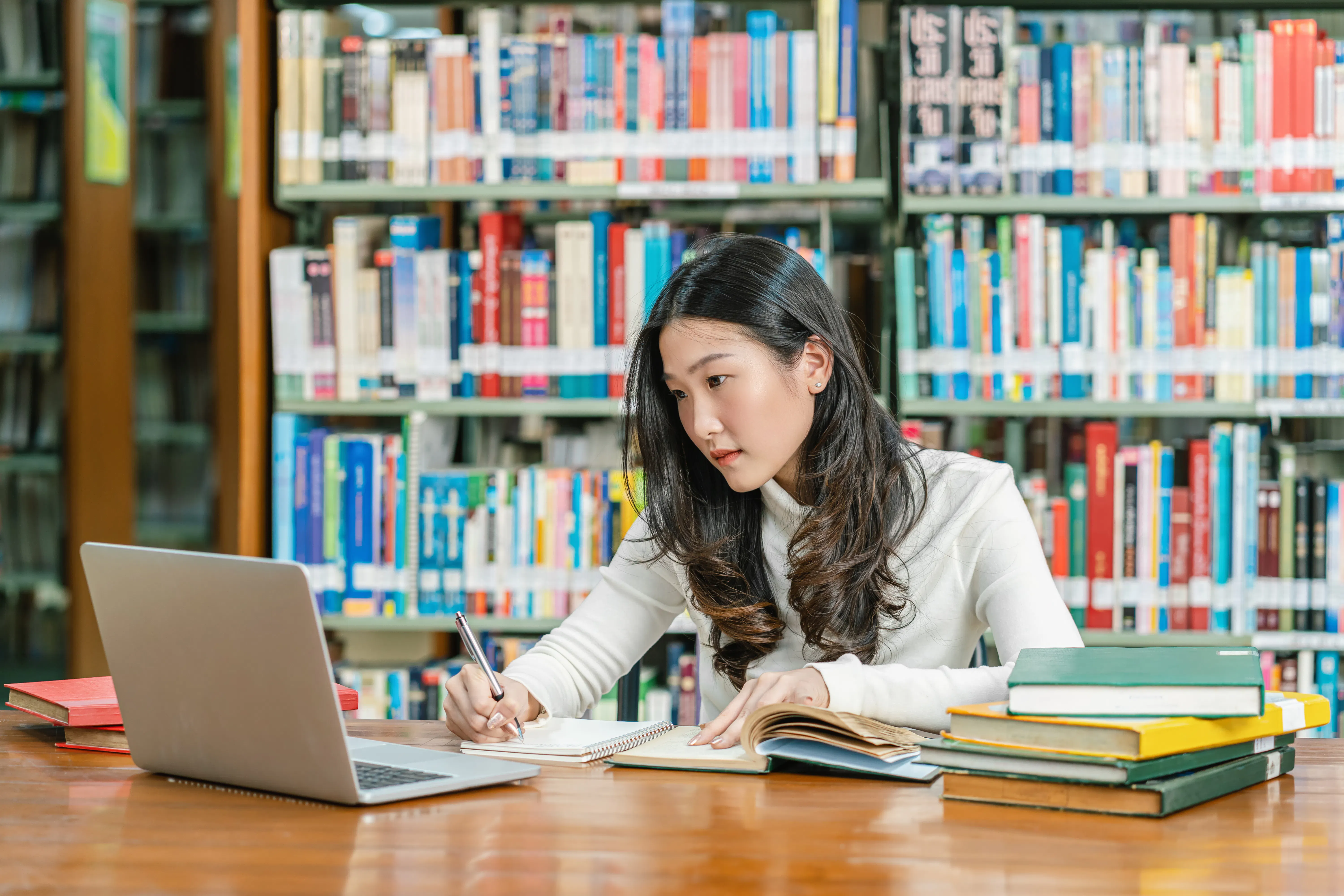 Asian woman doing research at library