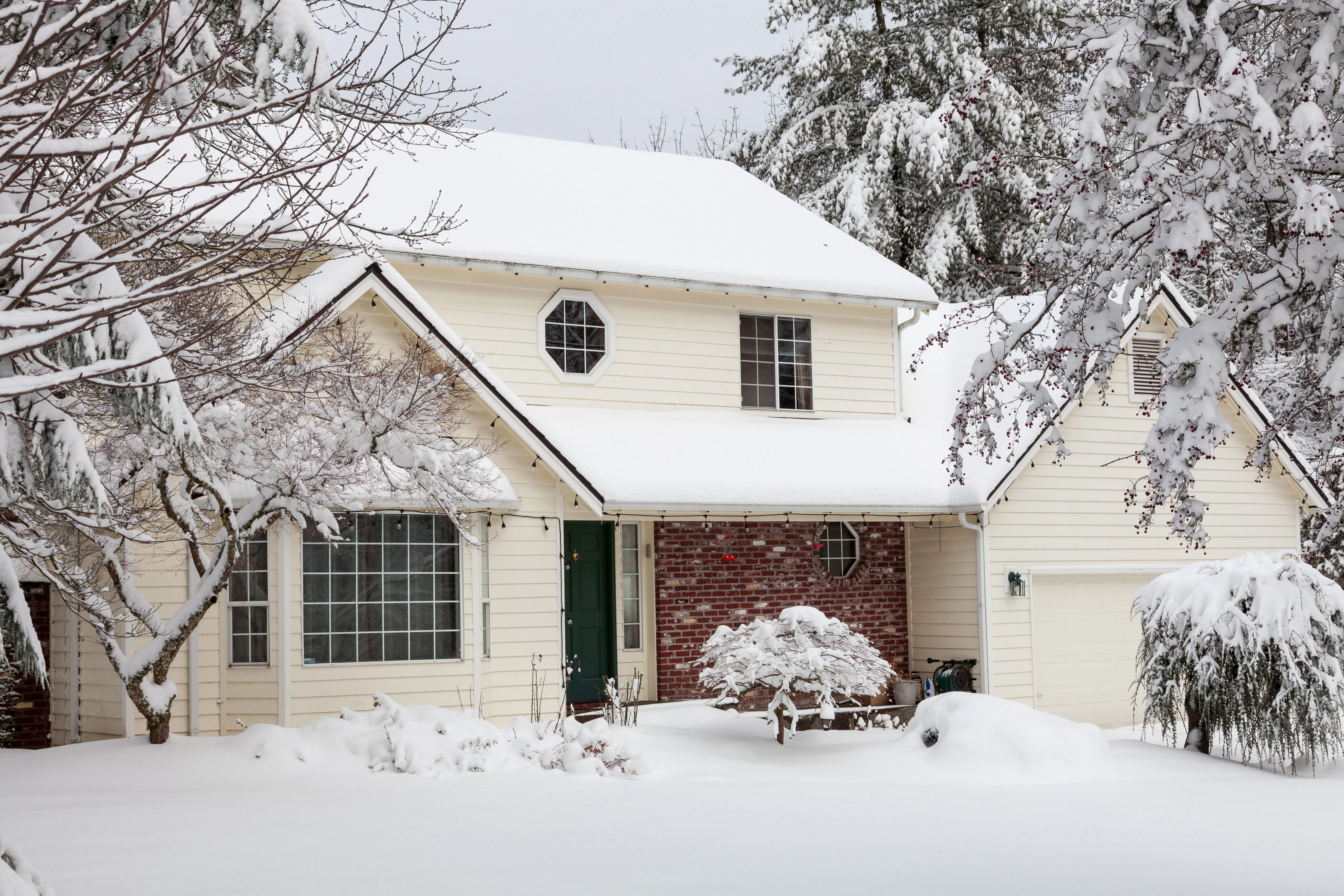 Residential home covered in snow