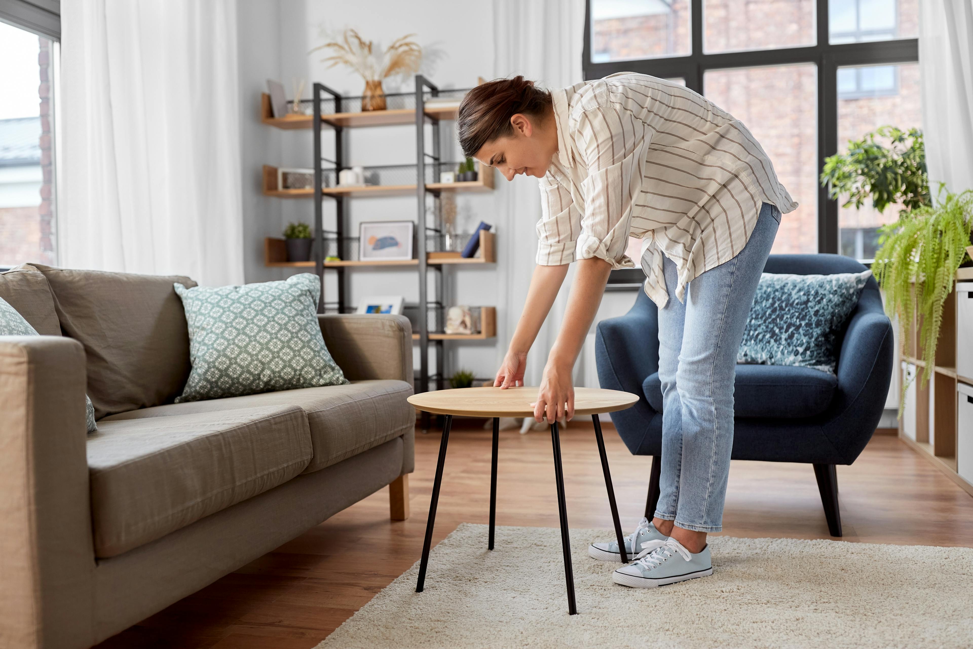 Woman arranging furniture