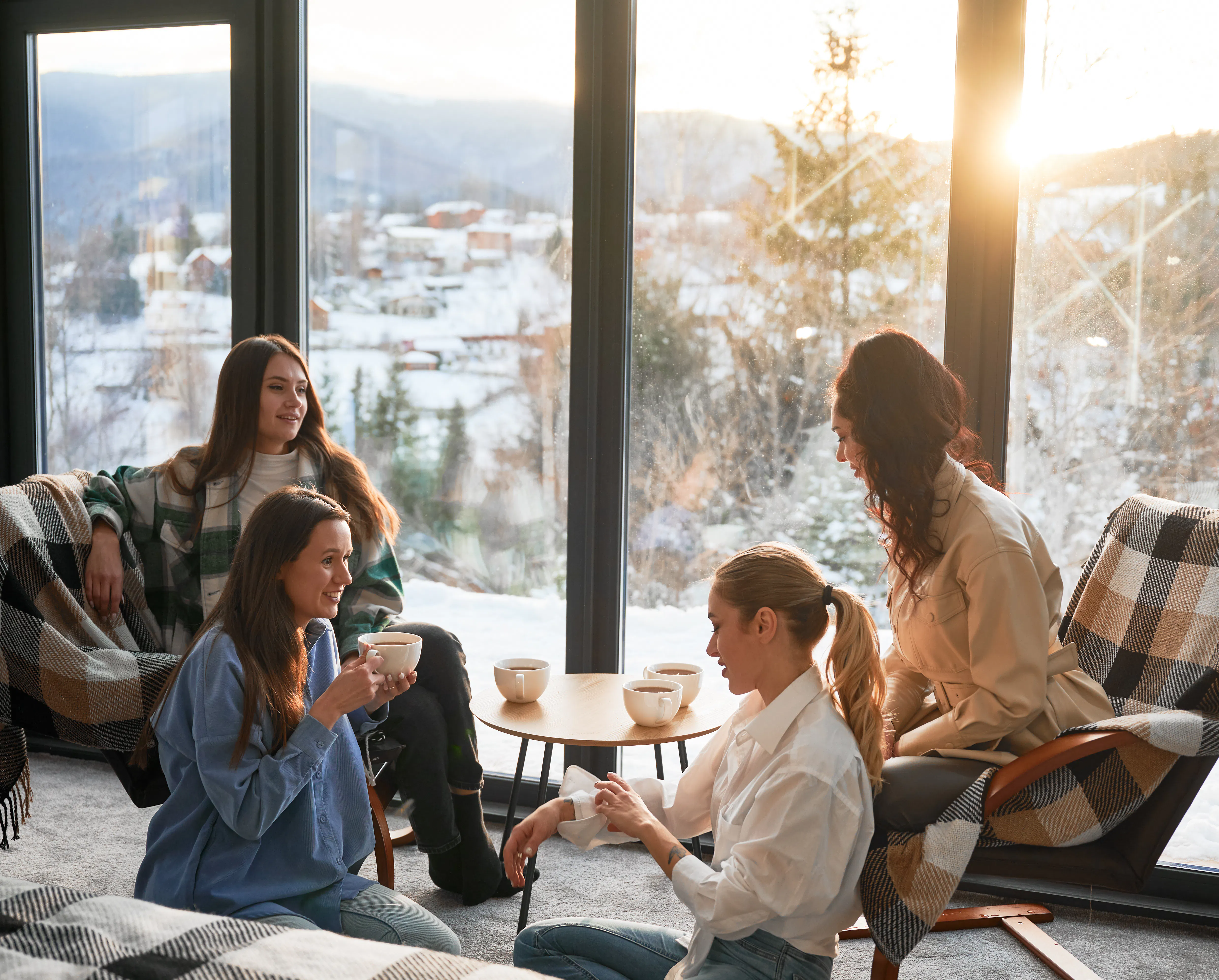 Young women enjoying winter weekends inside contemporary barn house.