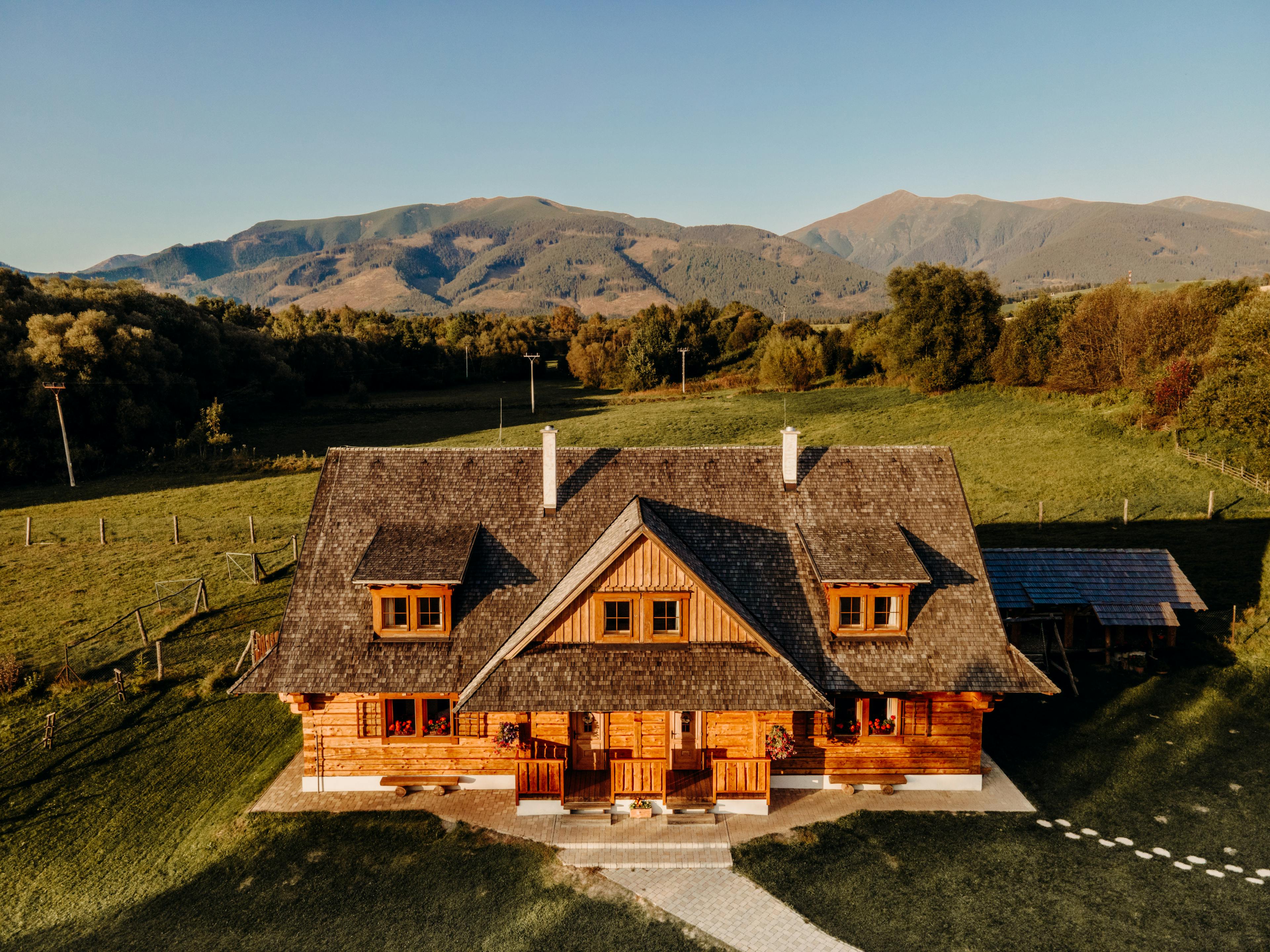 Wooden cottage in nature in sunny day. Recreation center in the mountains. Modern eko hausing in nature