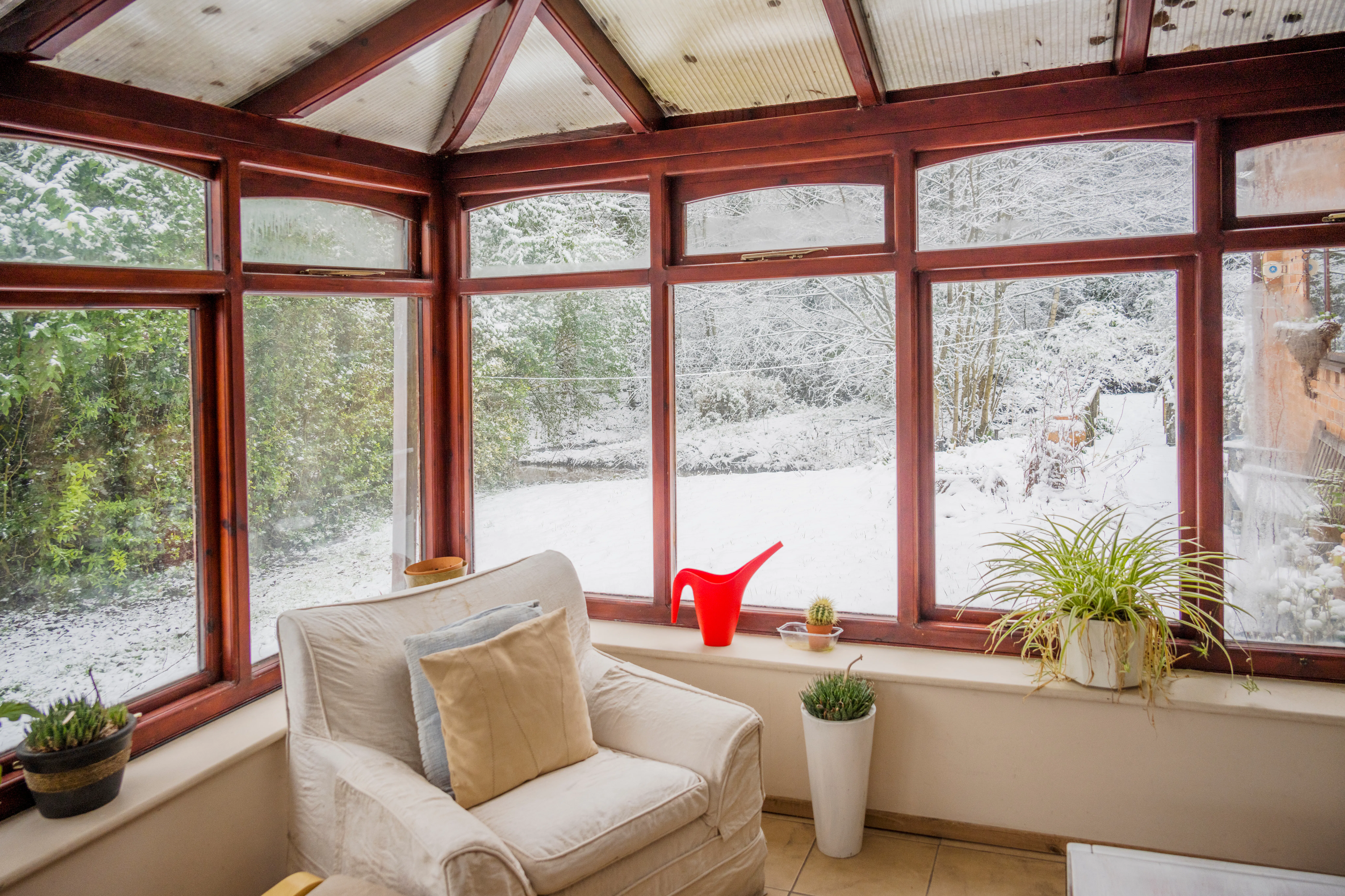 Conservatory with snow in garden outside