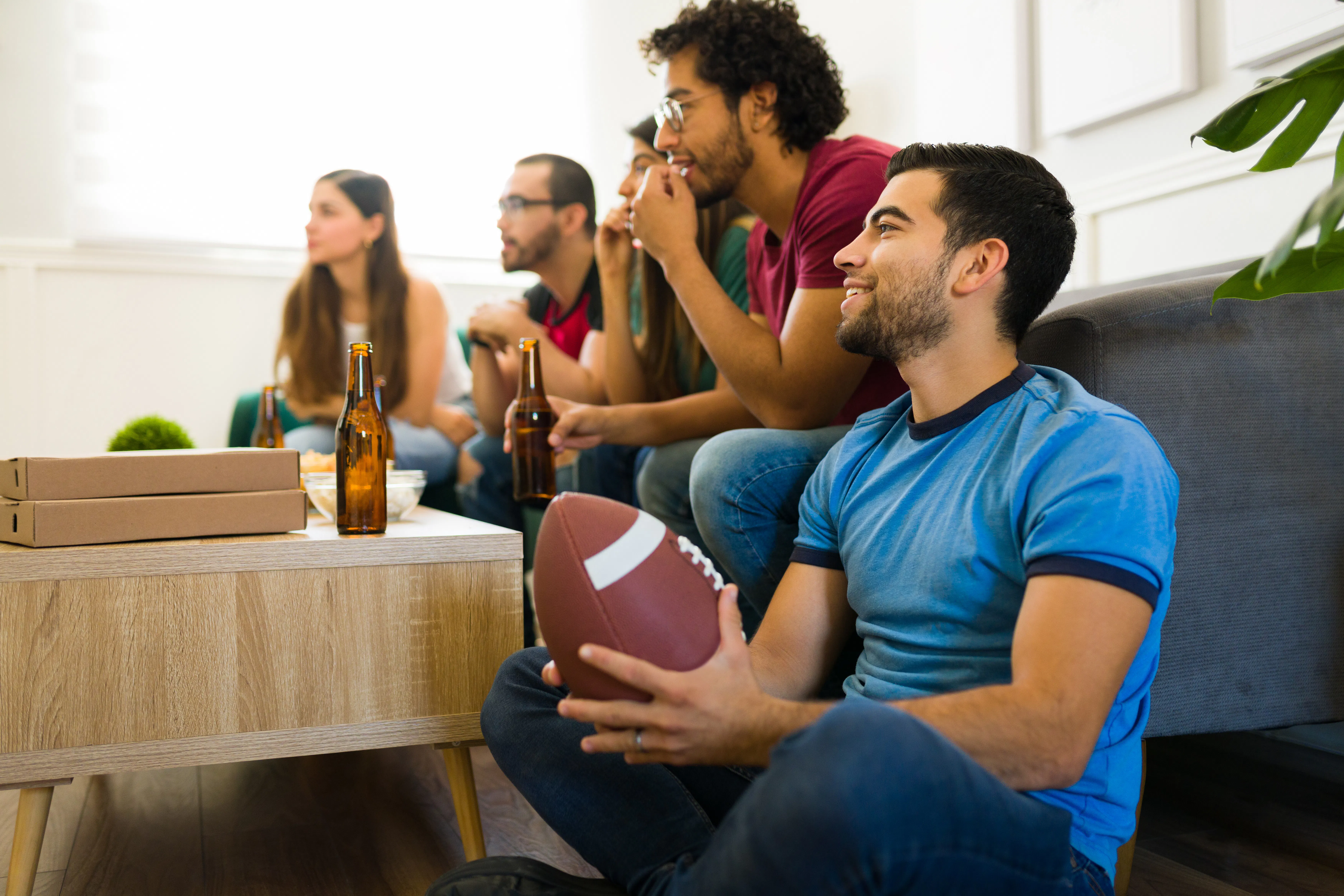 Football fans watching the game at home
