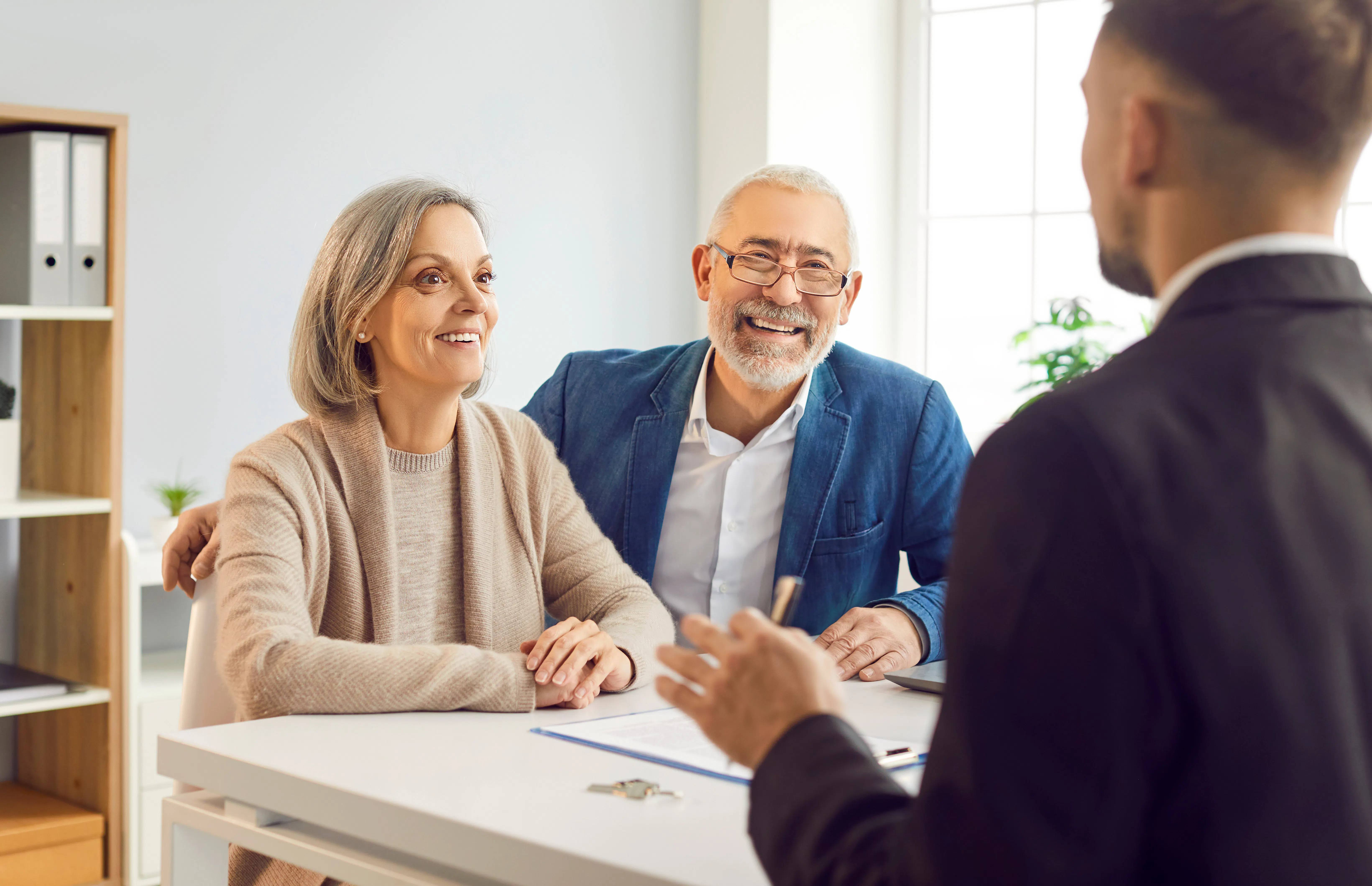 Older couple meeting with real estate agent