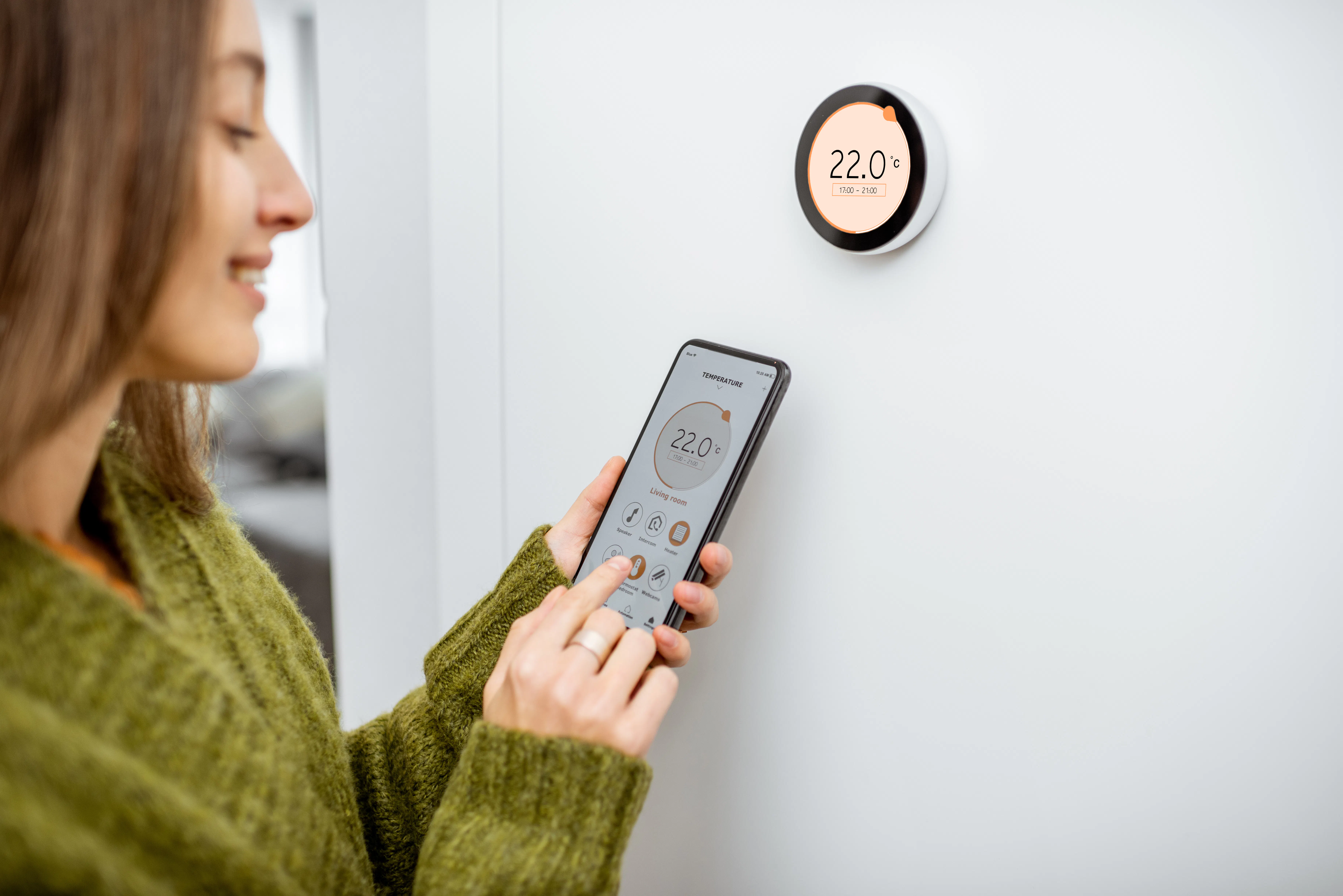 Woman controlling thermostat from app