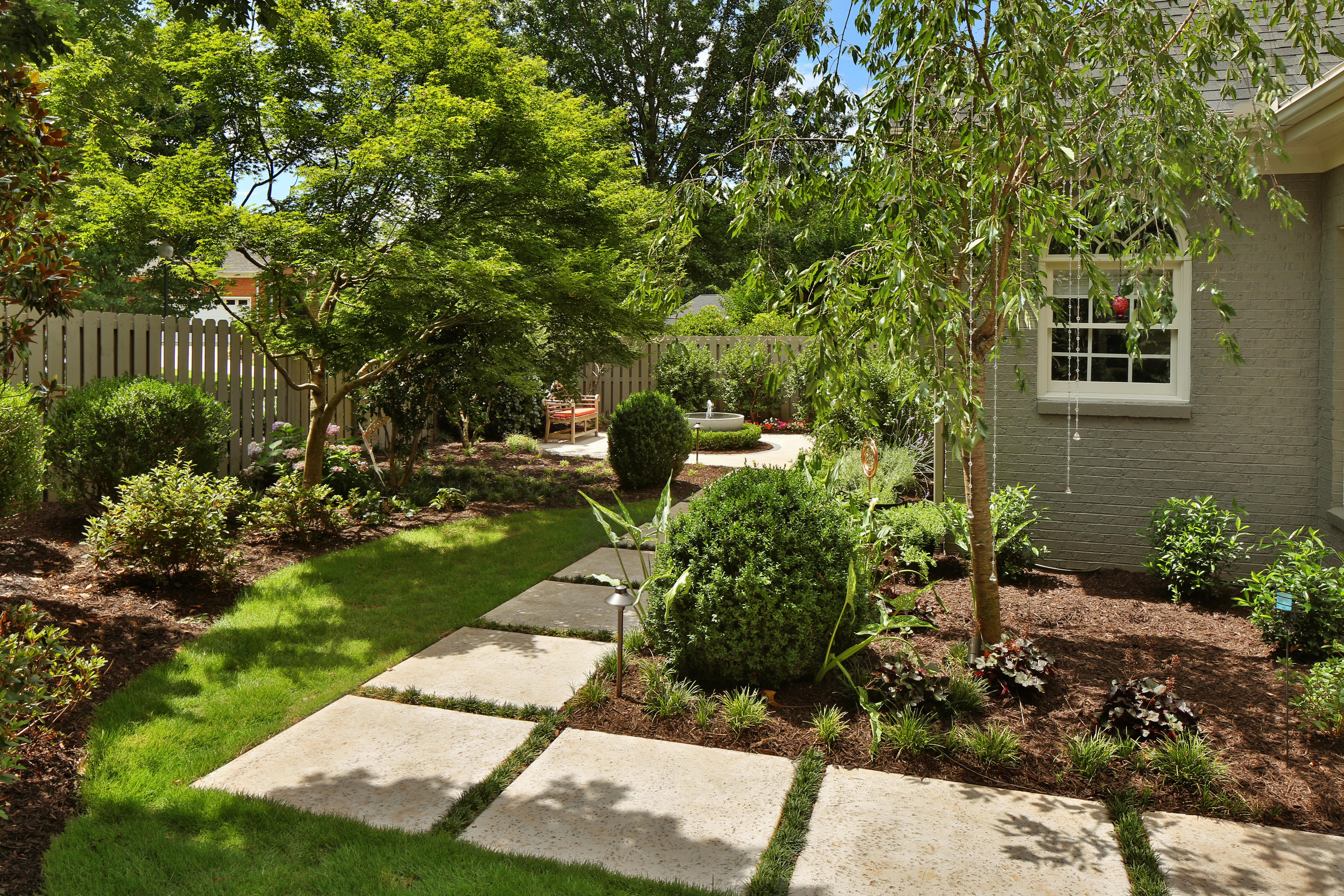 Stone path through backyard garden