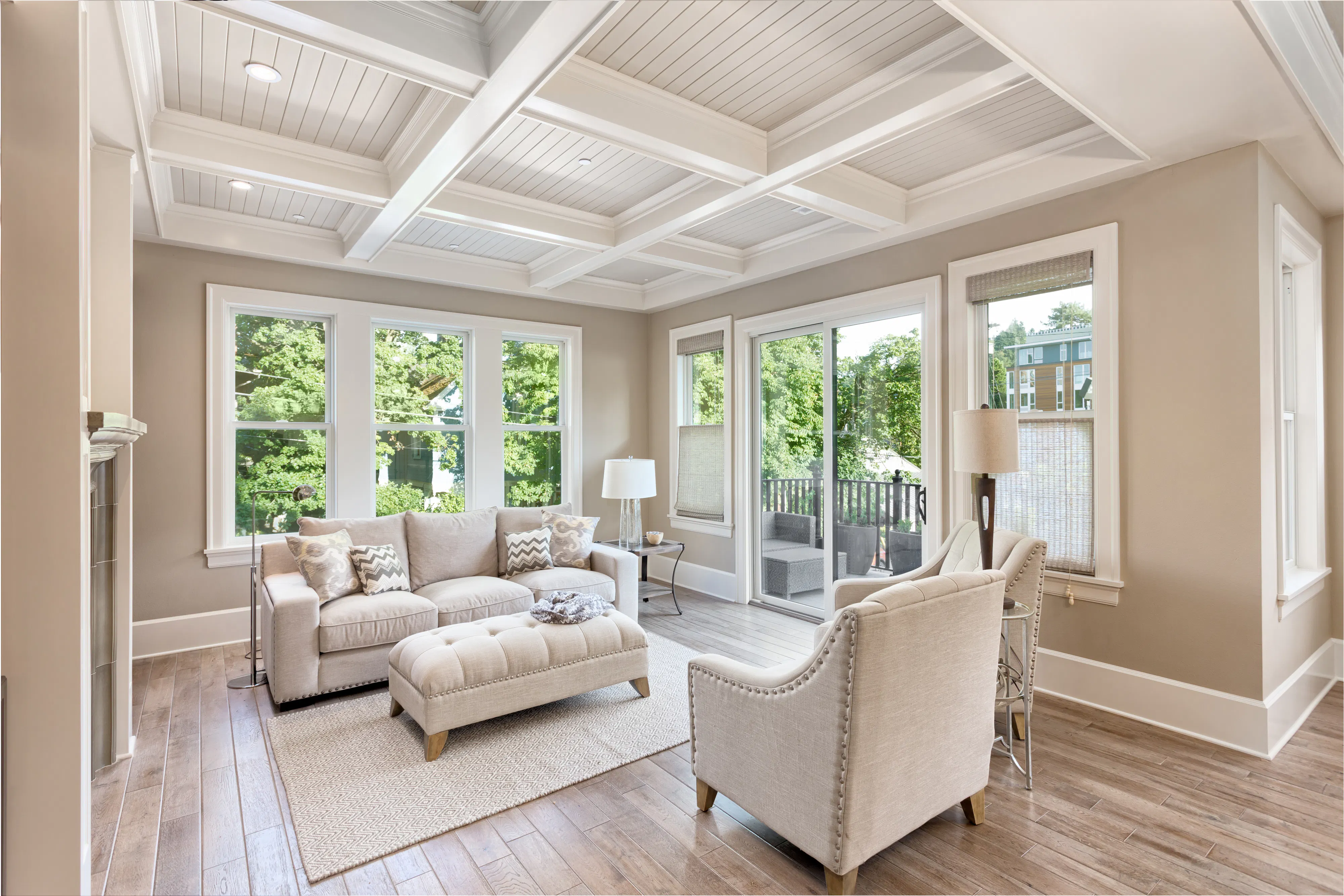Beautiful living room with hardwood floors in new home. Coffered ceiling adds elegant touch to this furnished living space