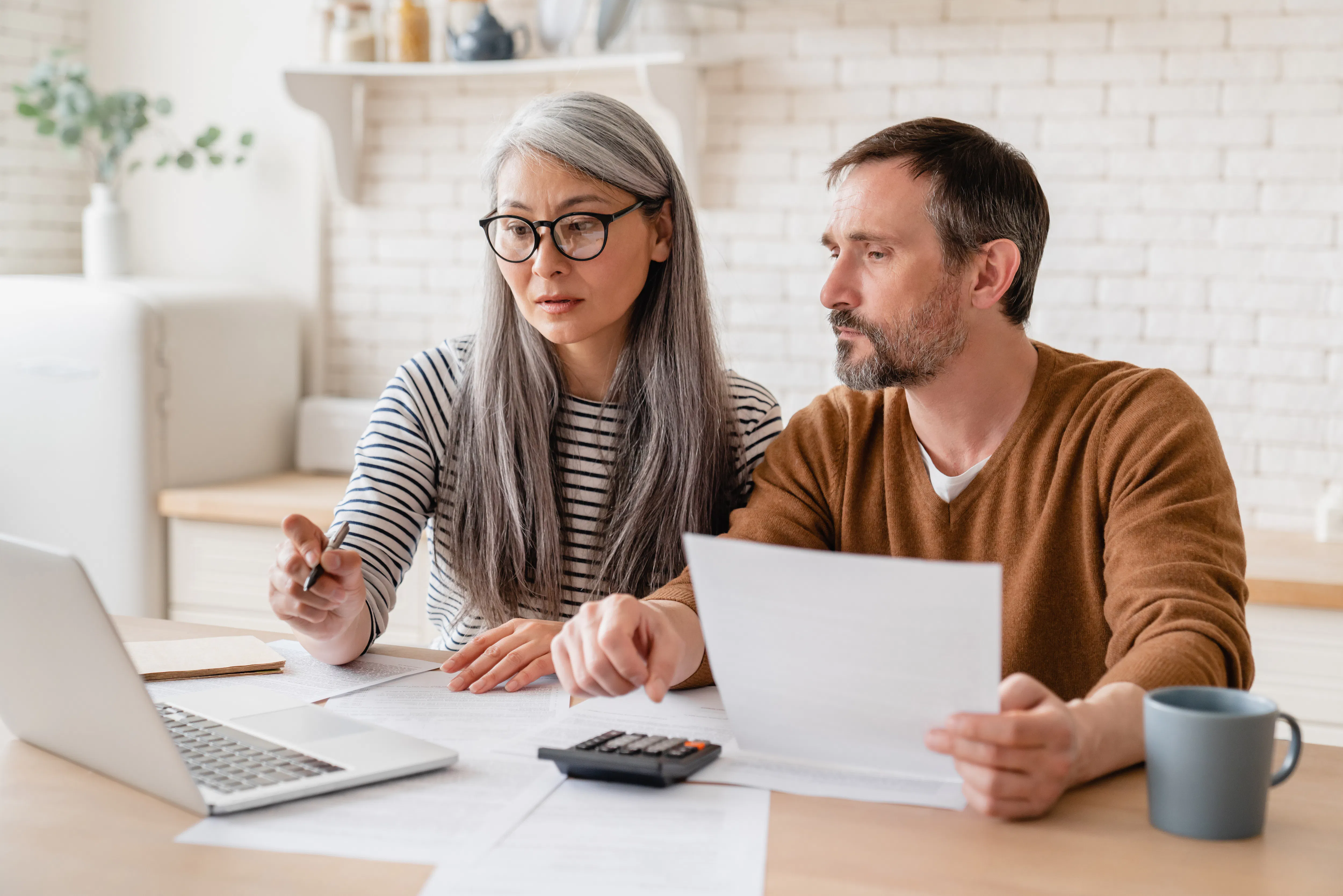 Mature middle-aged couple doing paperwork.