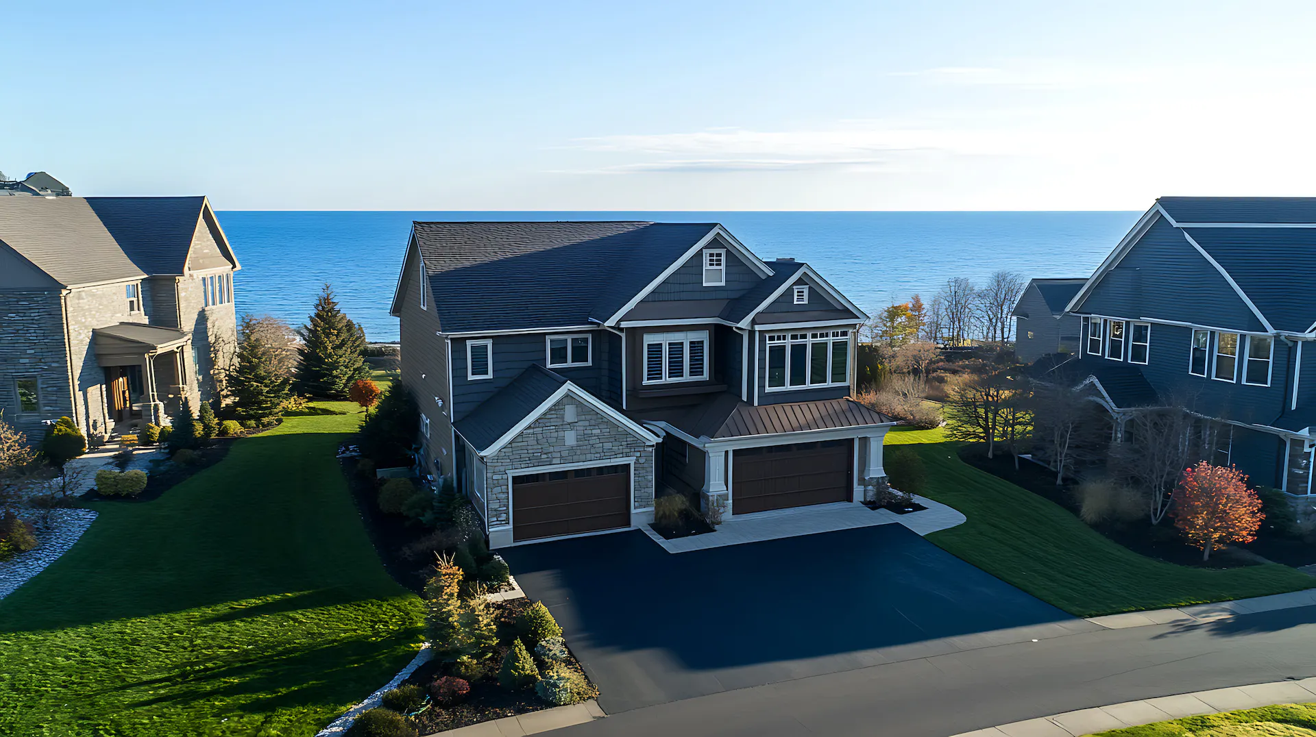 Aerial view of the exterior of a home along the shoreline of Lake Michigan.