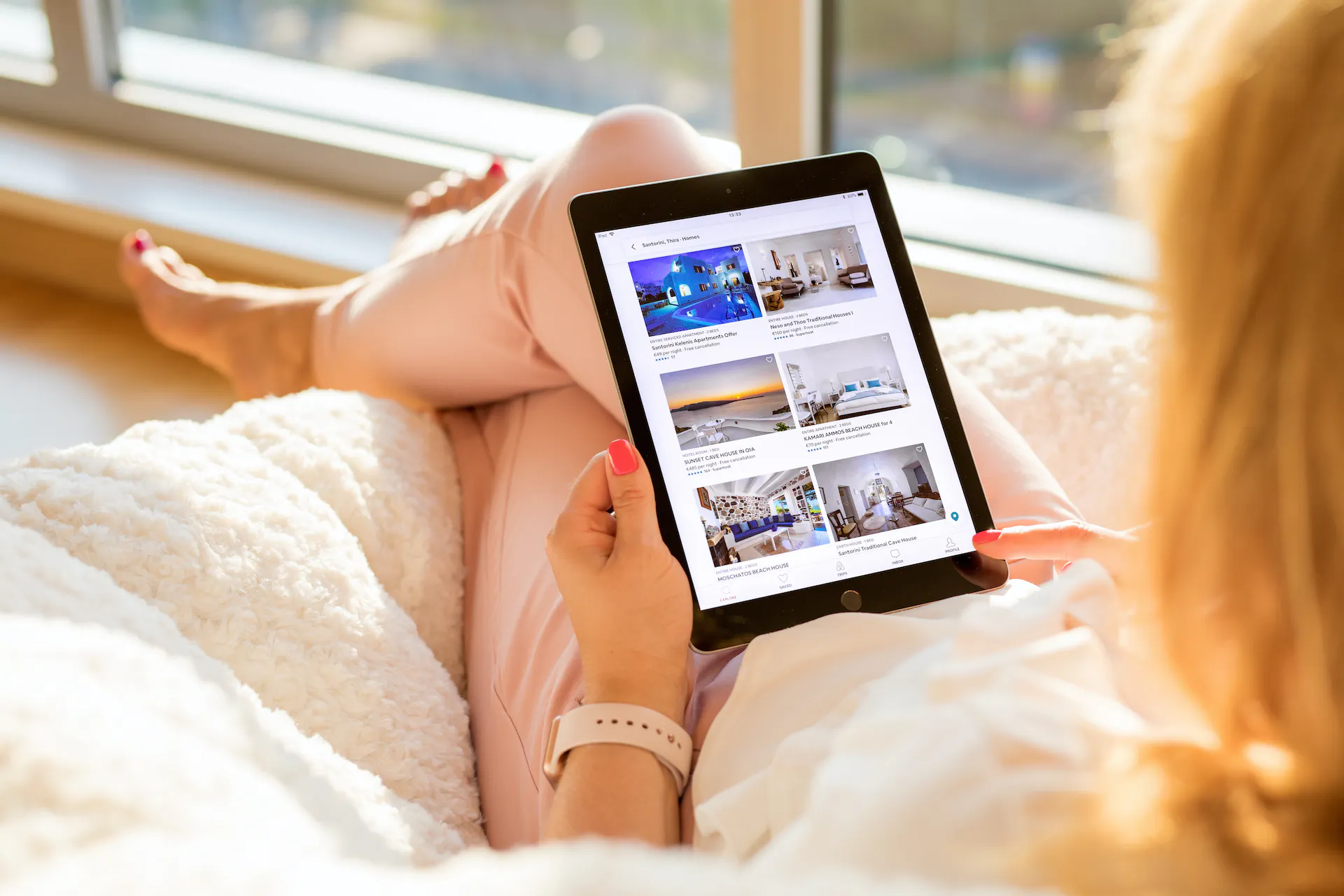 Woman looking at Airbnb website on iPad.
