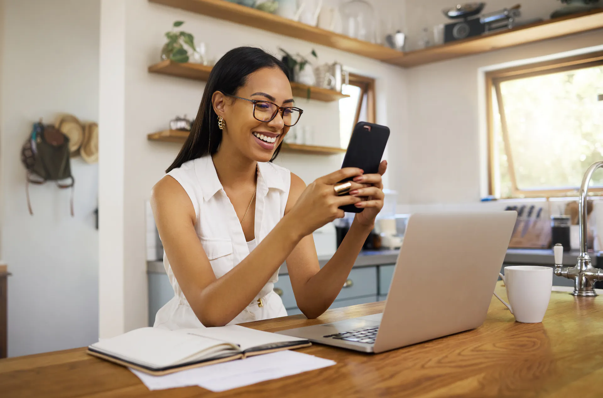 Woman using her phone to communicate, connect, and text while smiling, happy, and relaxed.
