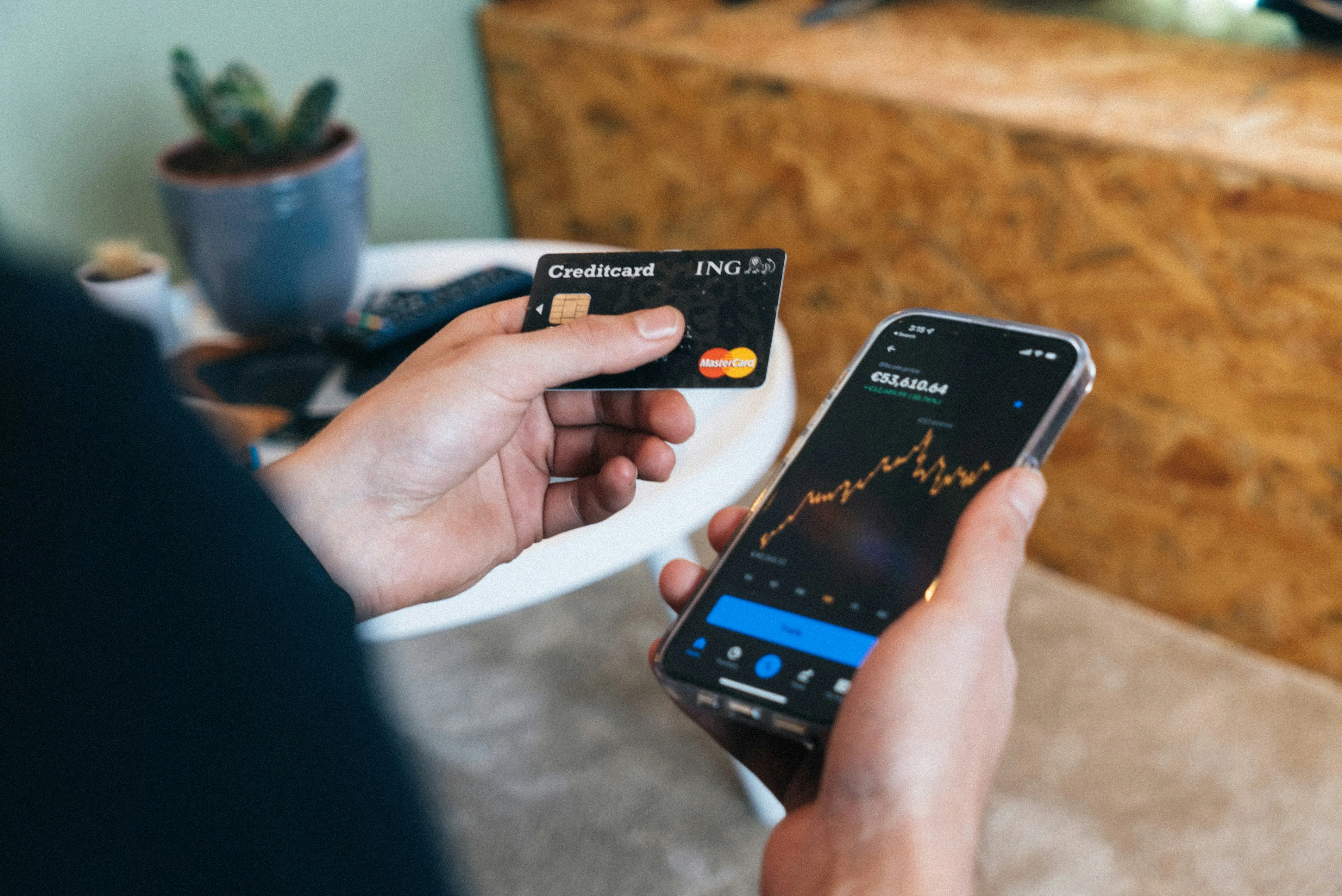 man holding credit card and phone