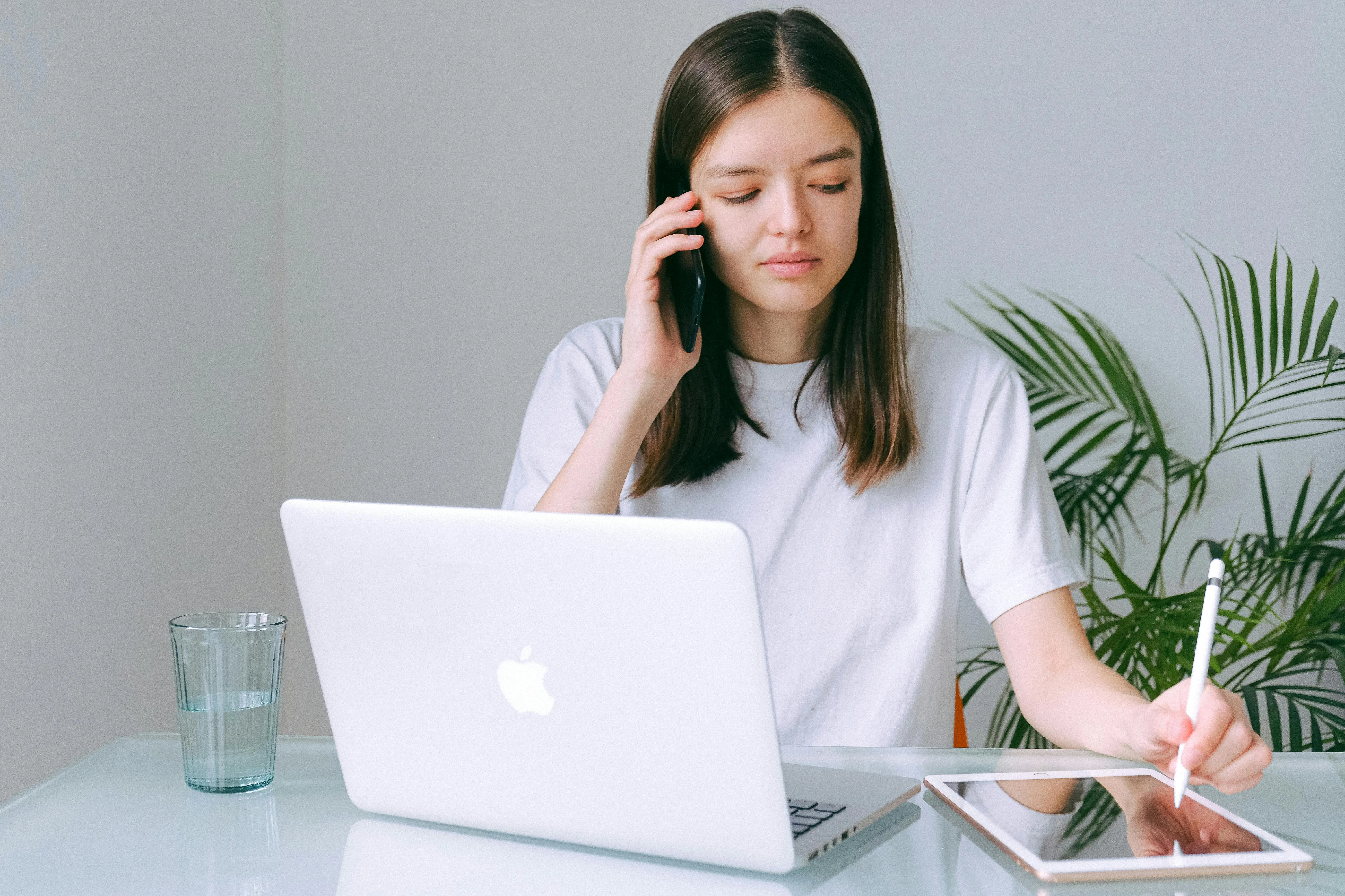 Woman on the phone with a laptop and tablet