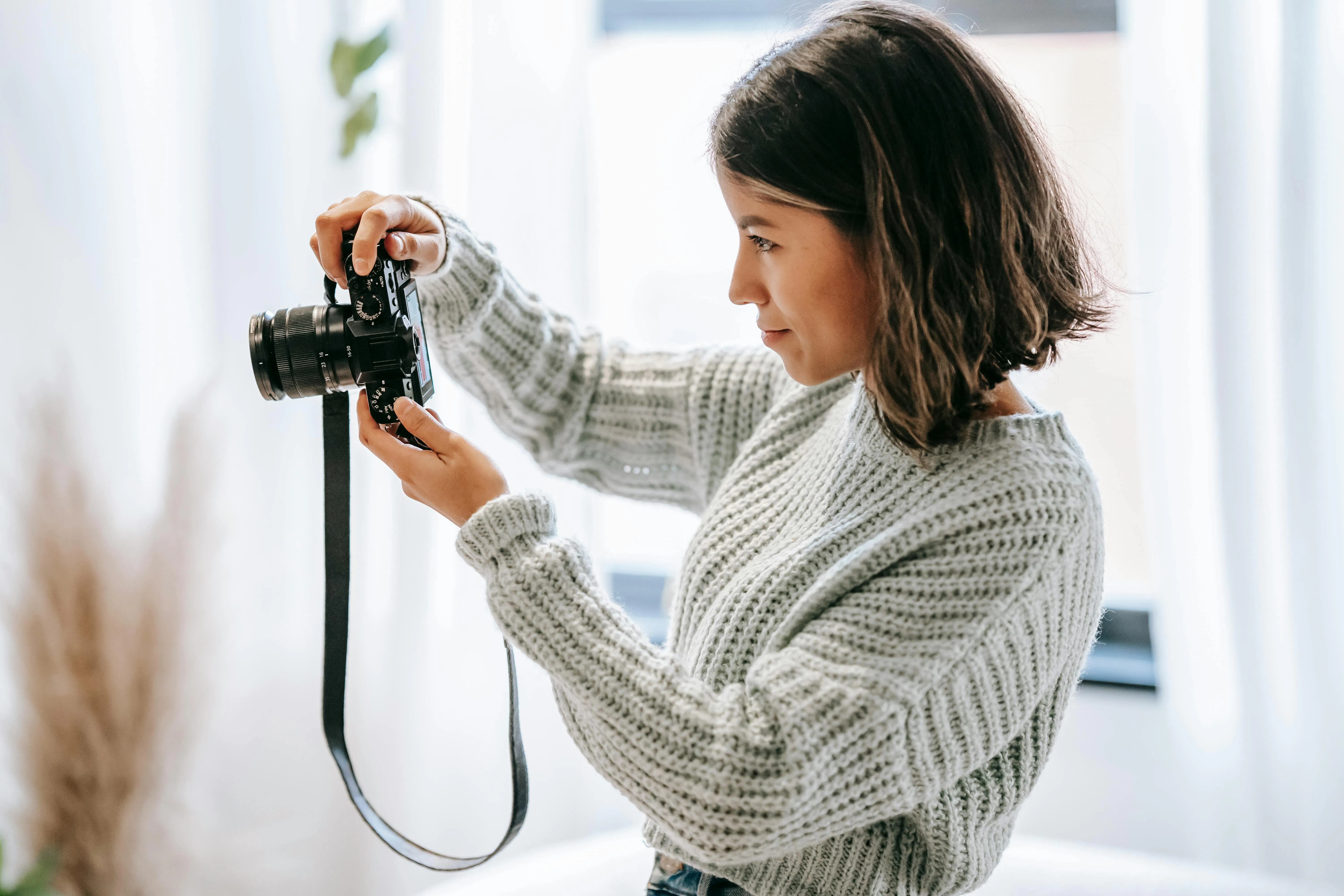 photographer taking photos on camera in house