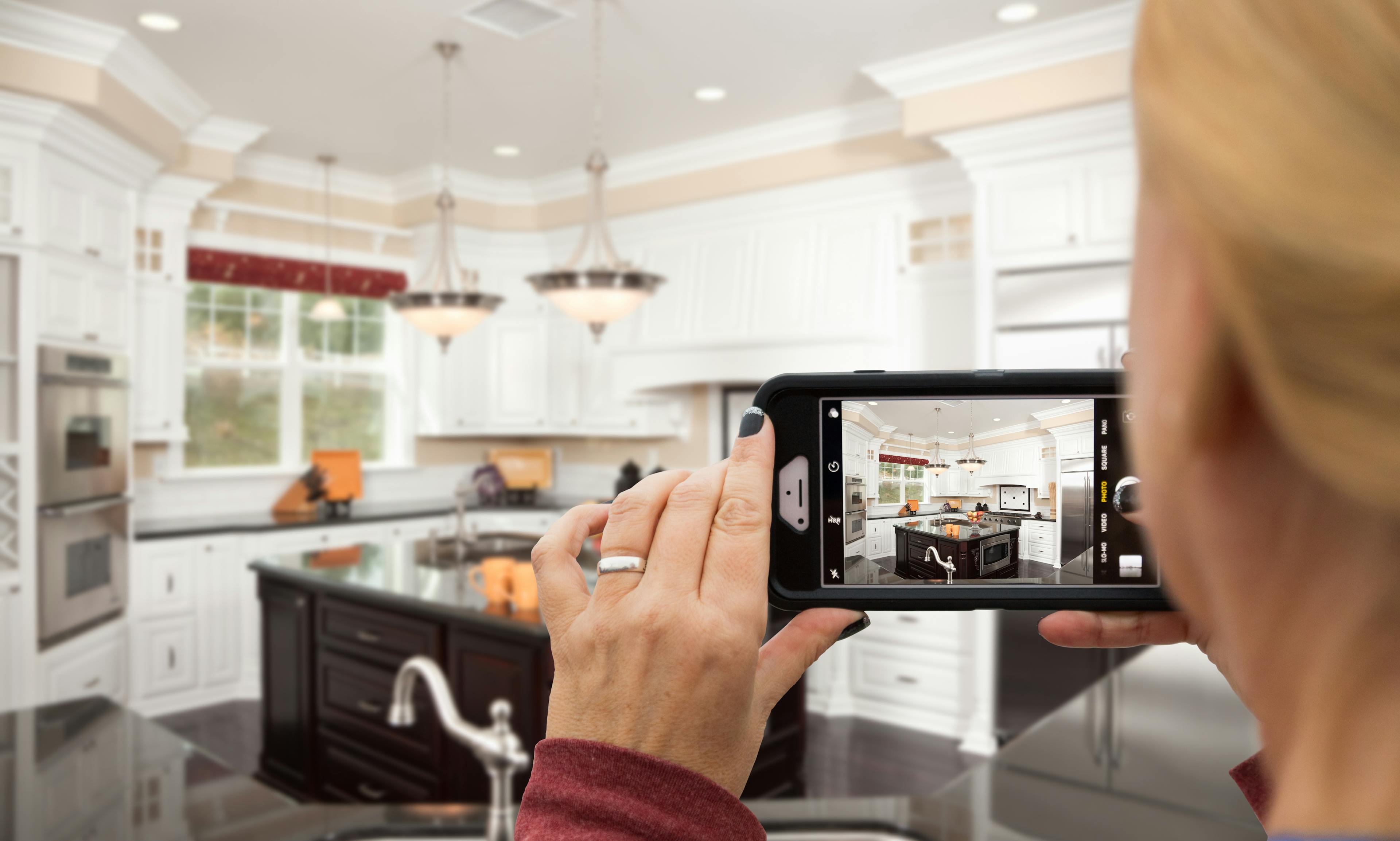 woman taking photo of kitchen