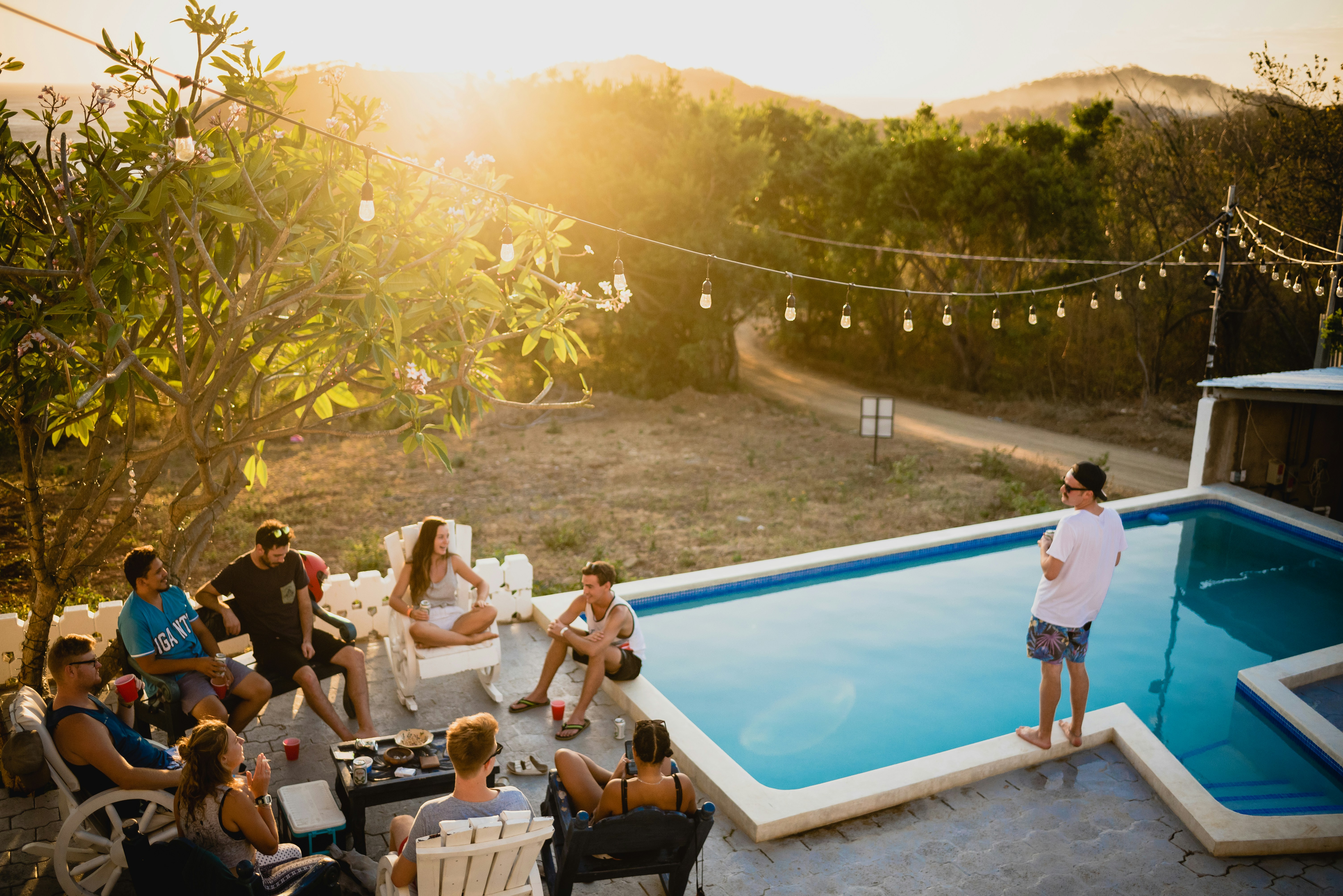 People gathered outside by a pool