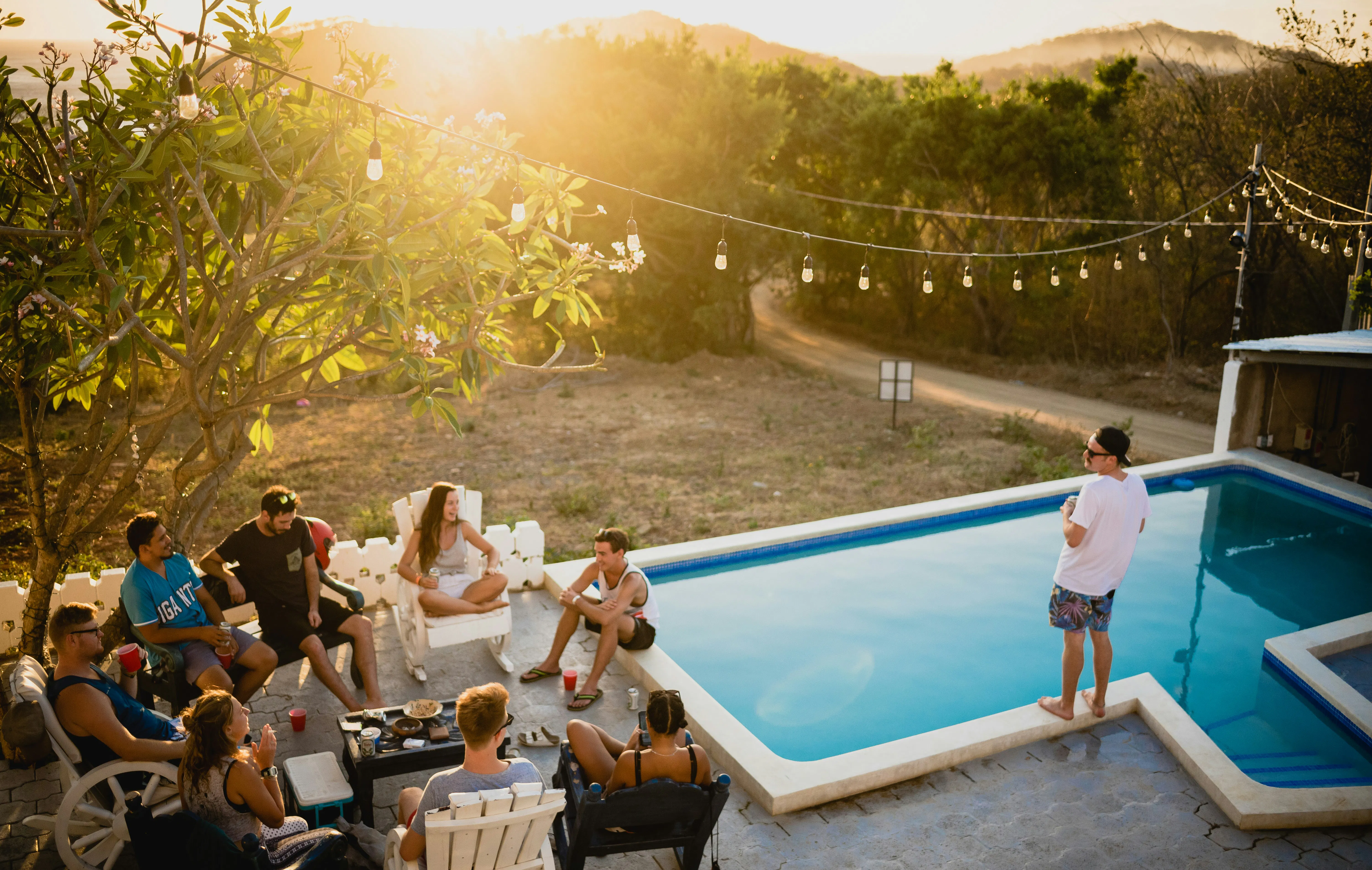 People gathered outside by a pool