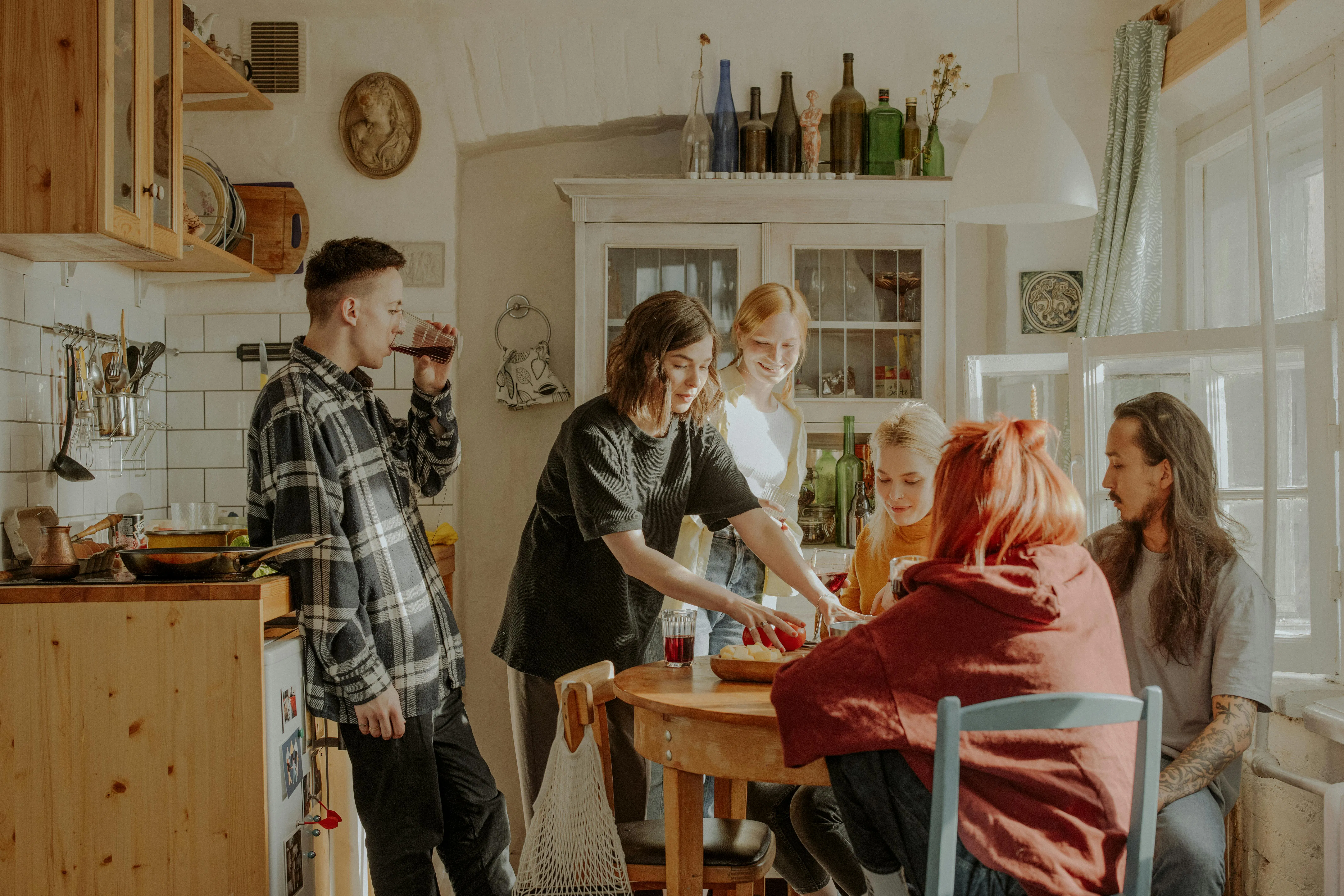 Group of people gathering in kitchen