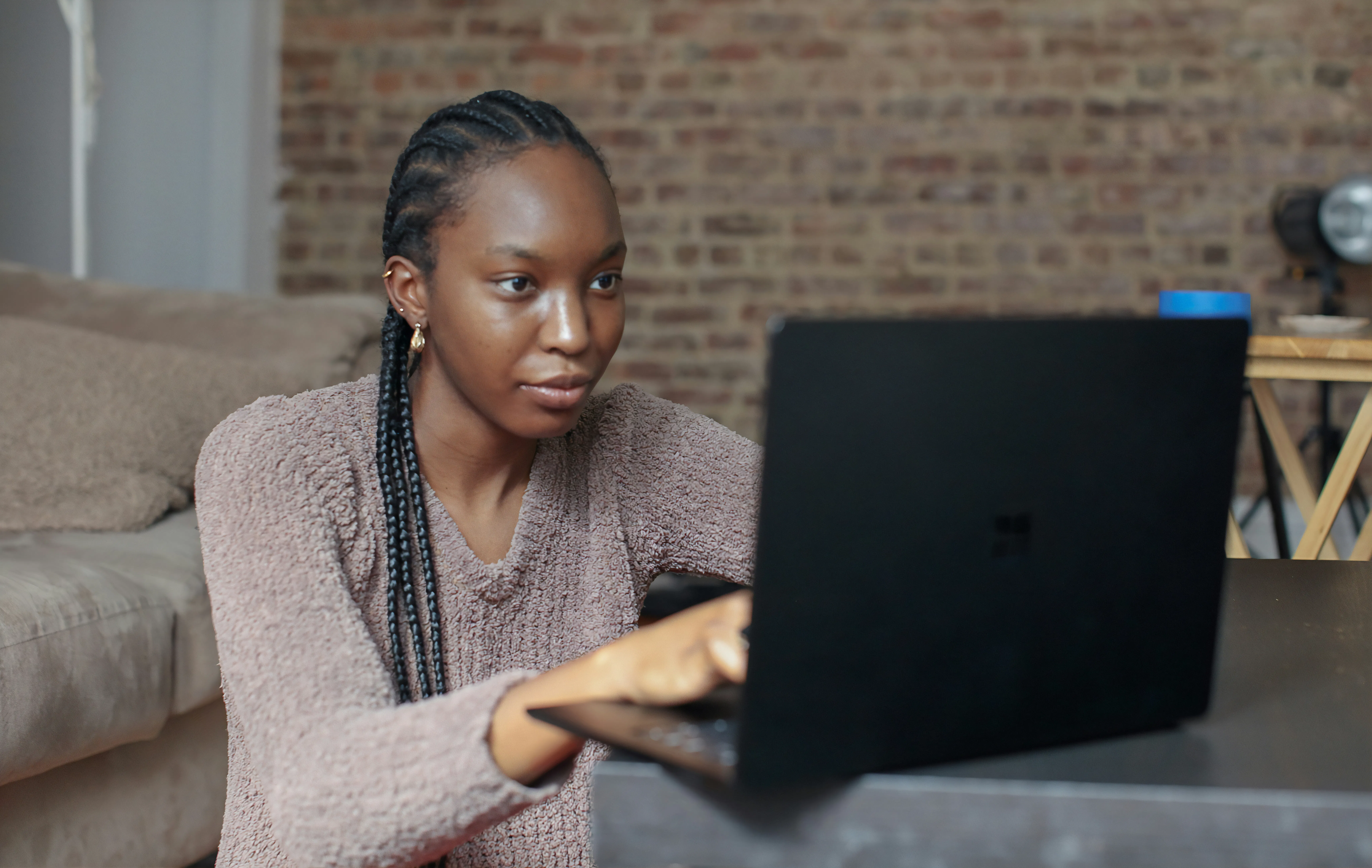 Woman sitting on the floor typing on a laptop