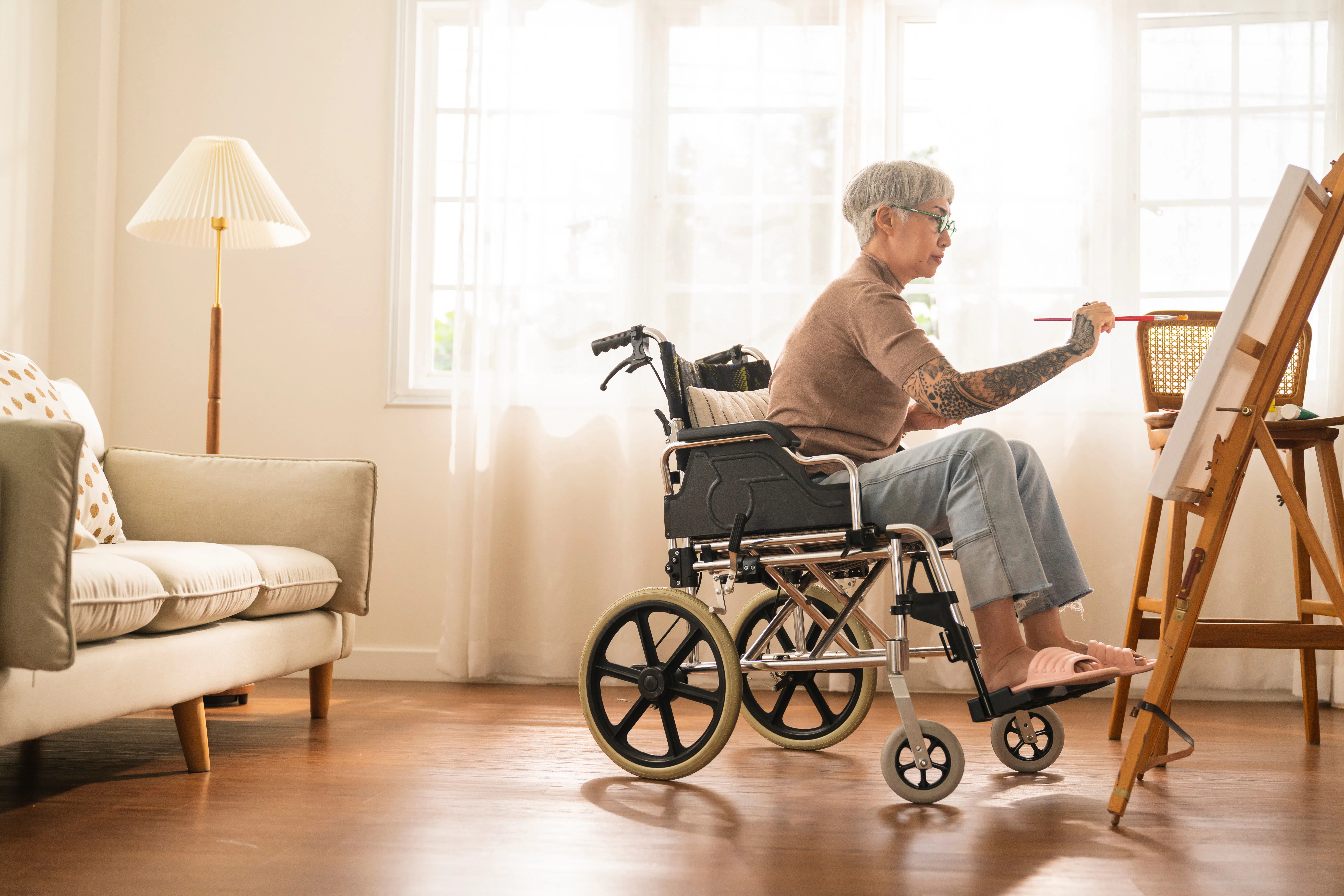 woman in wheelchair painting