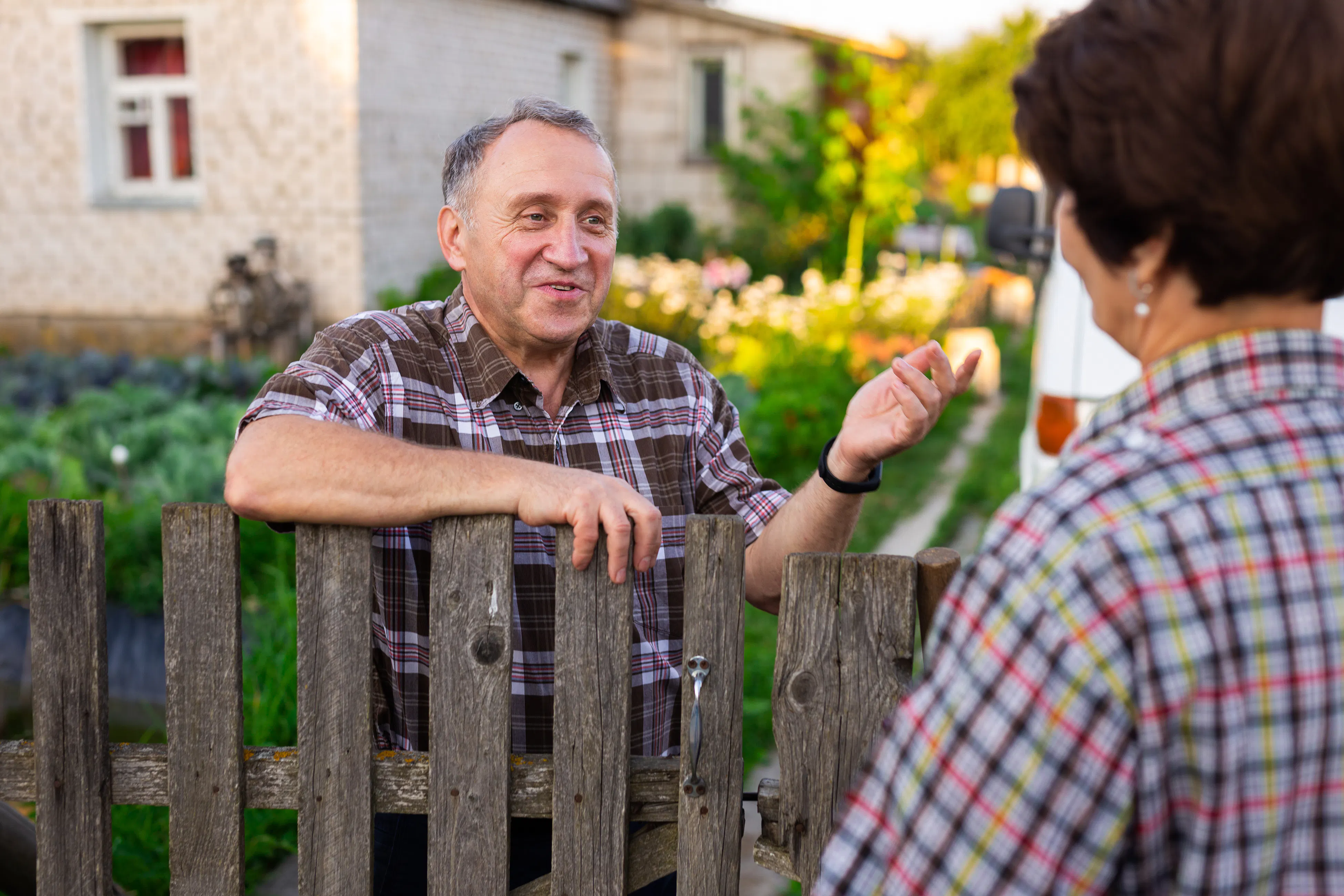 Neighbors talking over fence