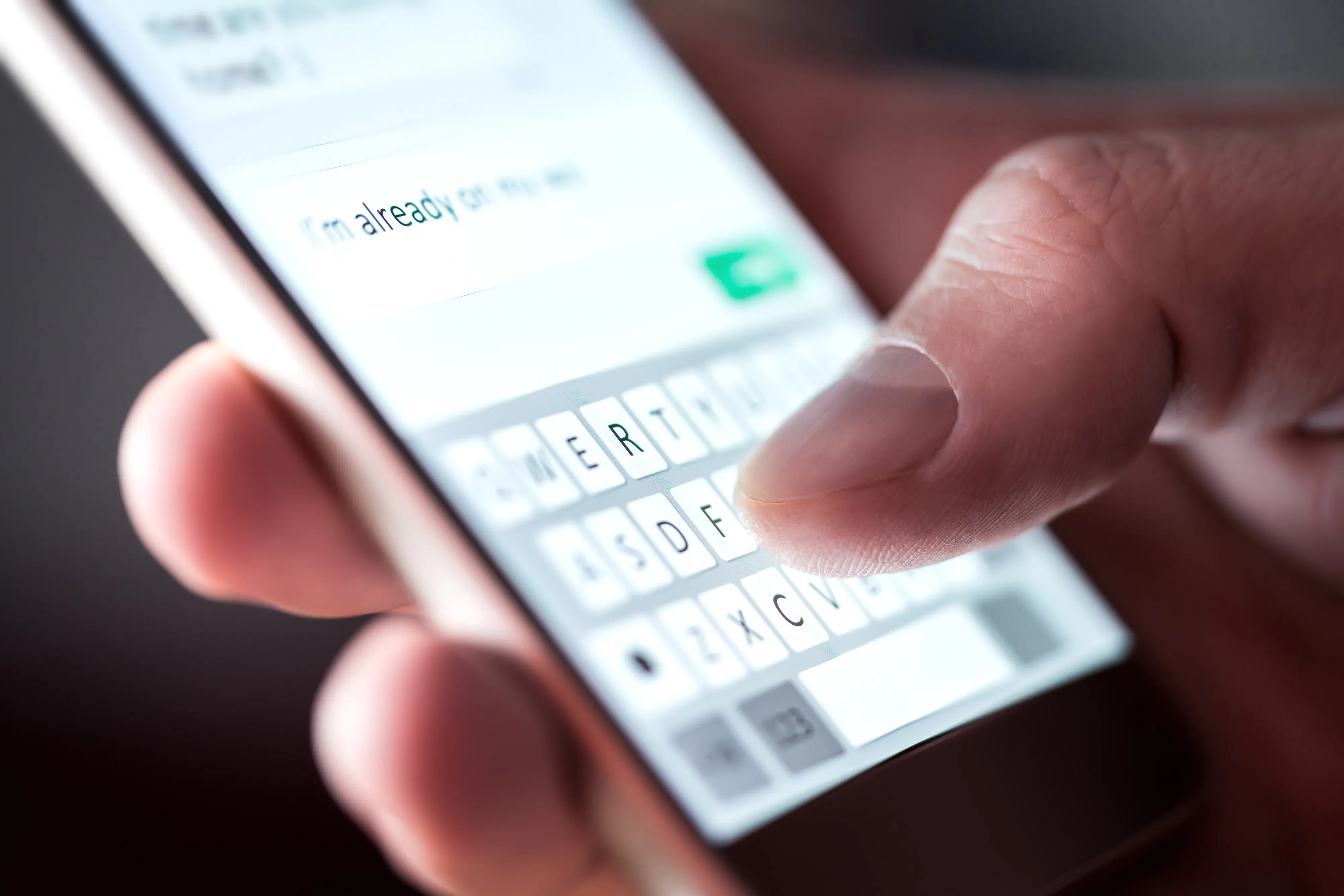 Man sending text message and sms with smartphone