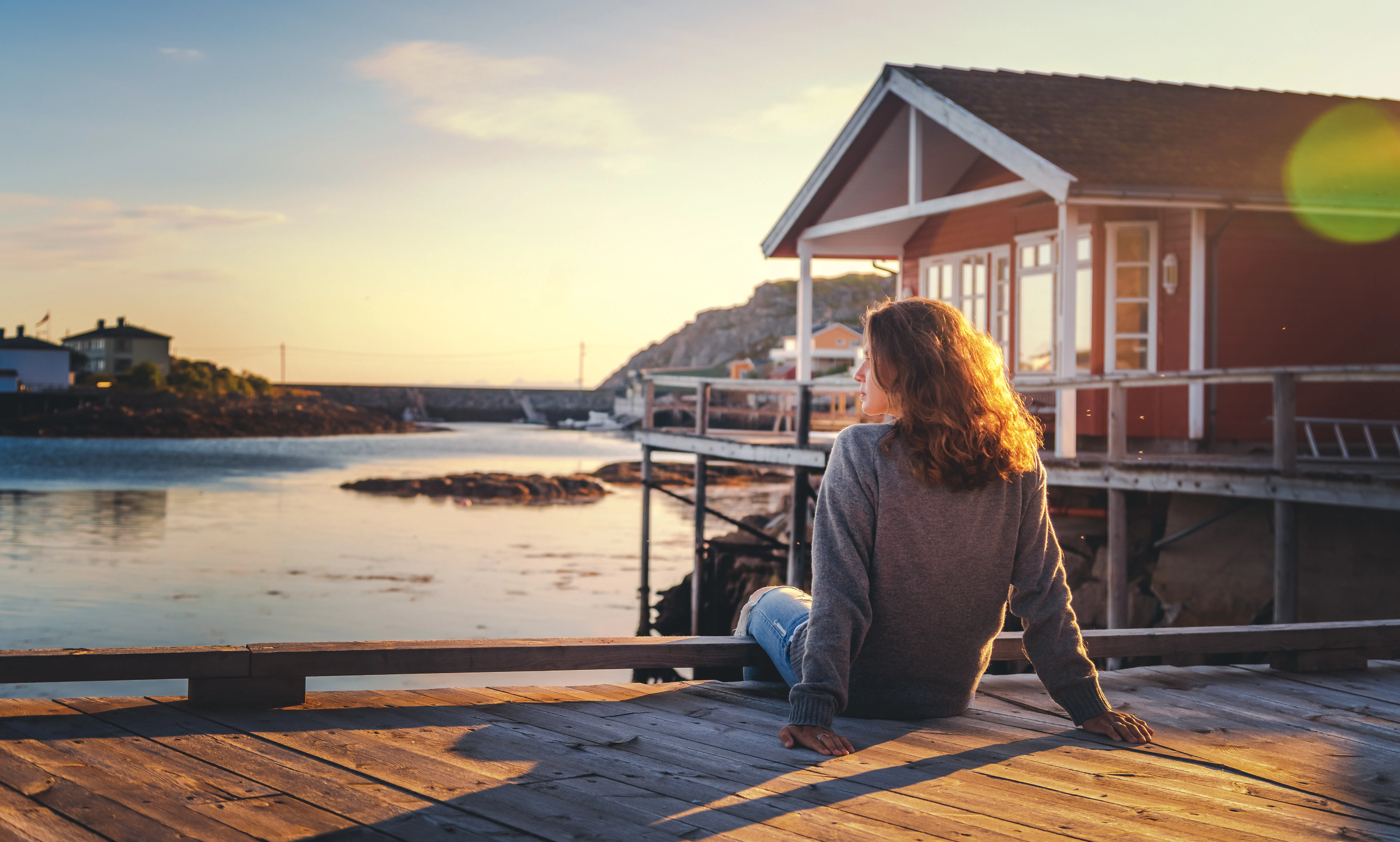 Girl sitting outside looking at water