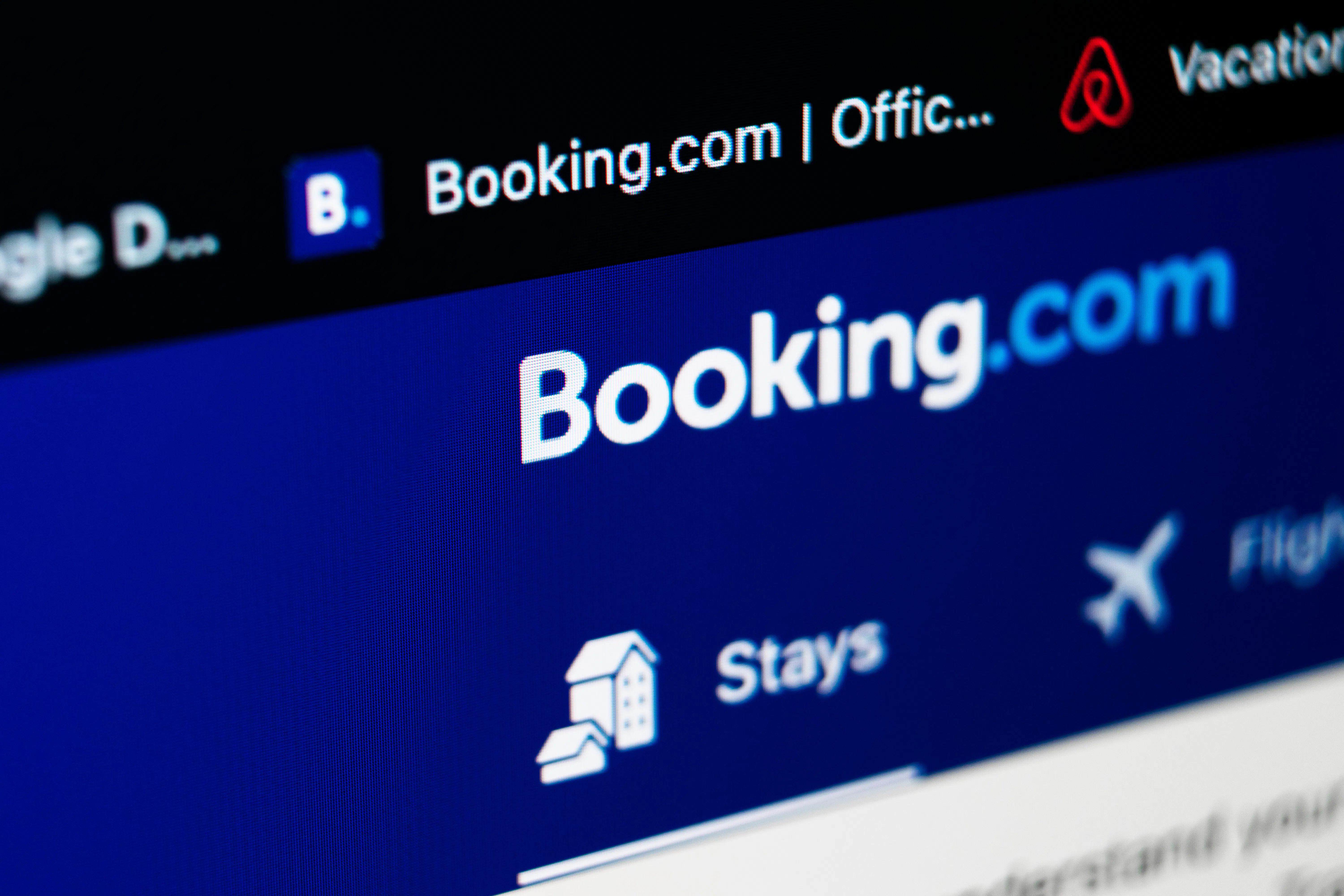 Booking.com application homepage icon on Apple iMac screen close-up. Booking app icon. Booking.com. Social media app.