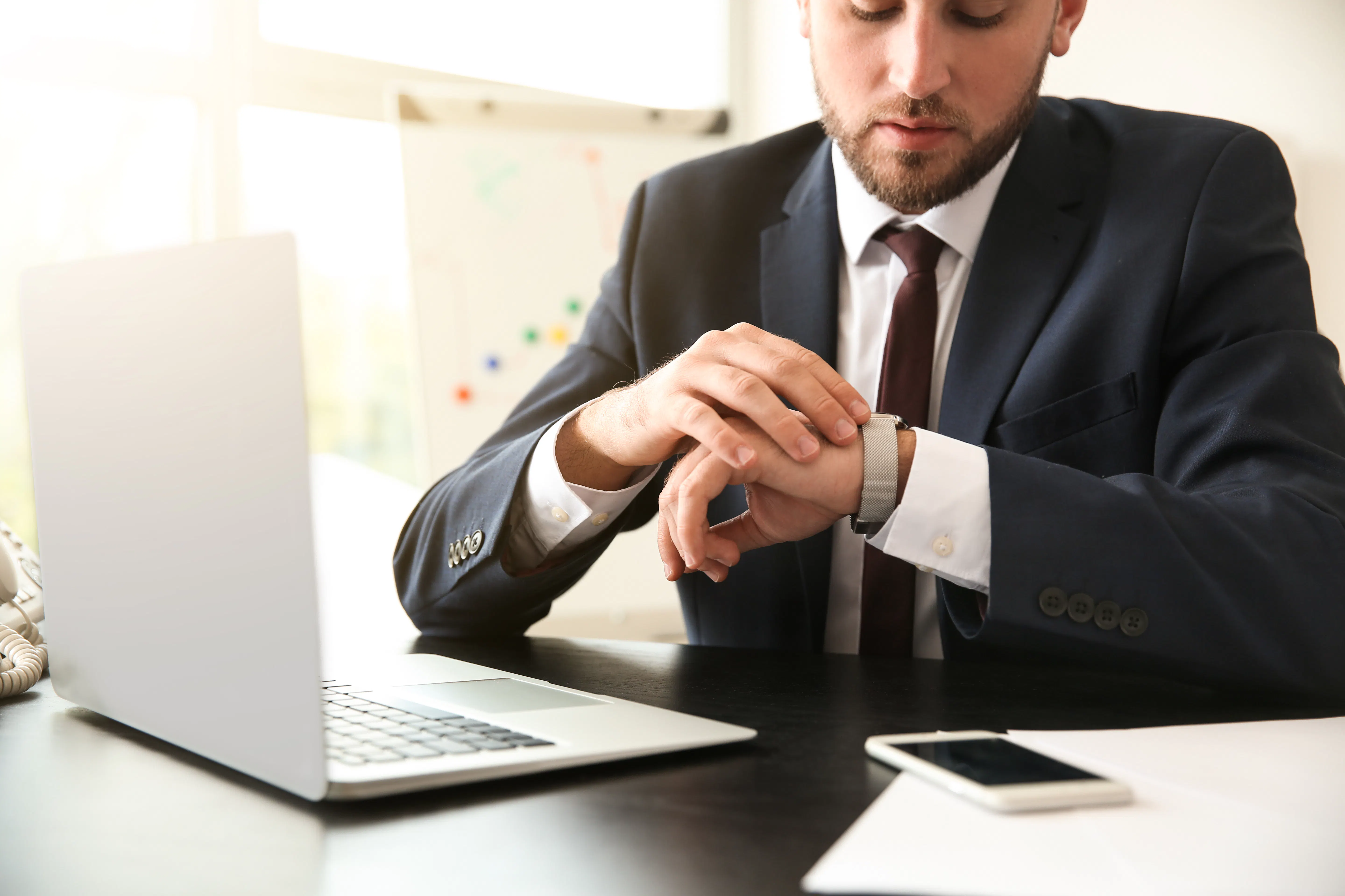 Person looking at his watch in work place